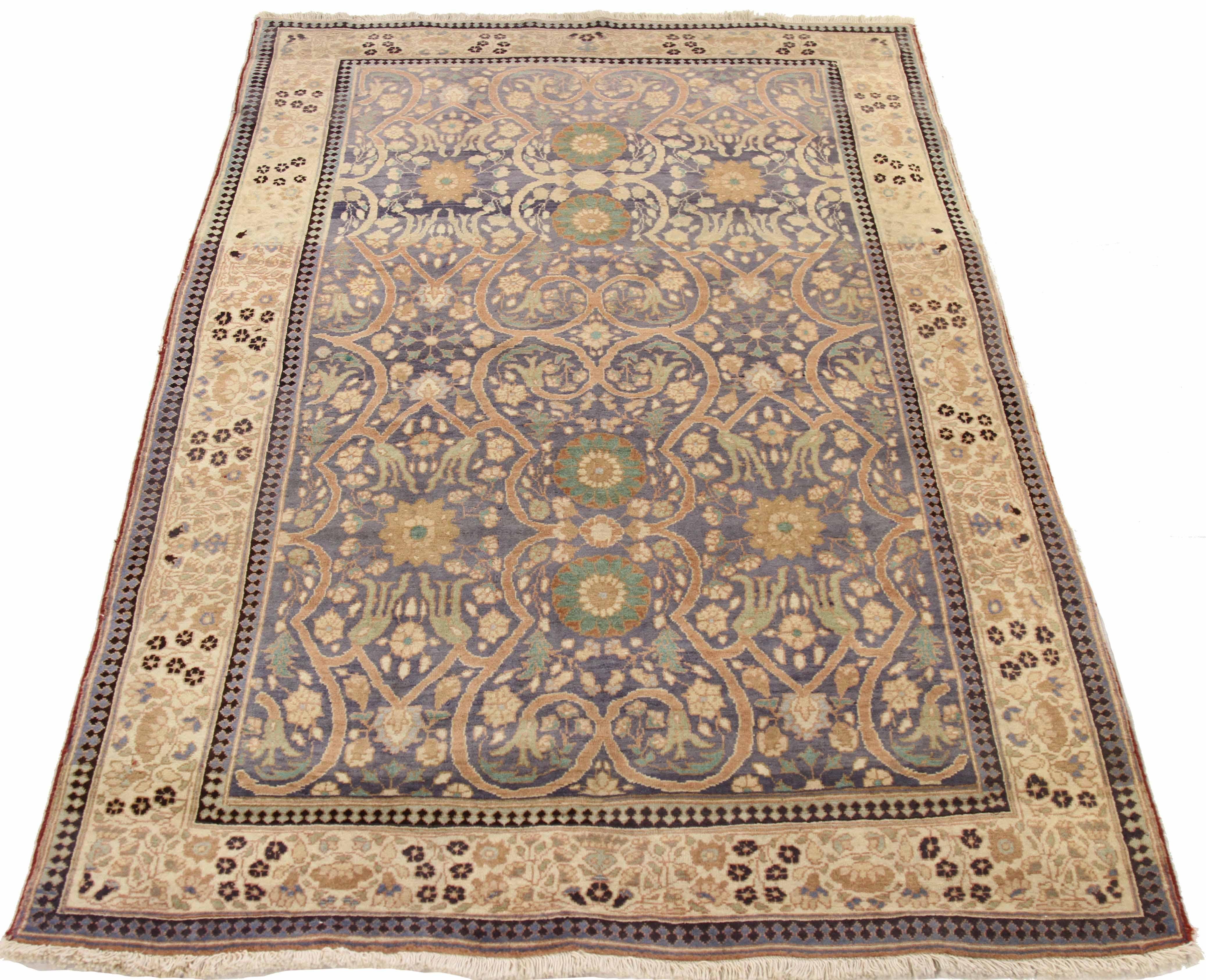 Antique Indian area rug handwoven from the finest sheep’s wool. It’s colored with all-natural vegetable dyes that are safe for humans and pets. It’s a traditional Agra design handwoven by expert artisans. It’s a lovely area rug that can be