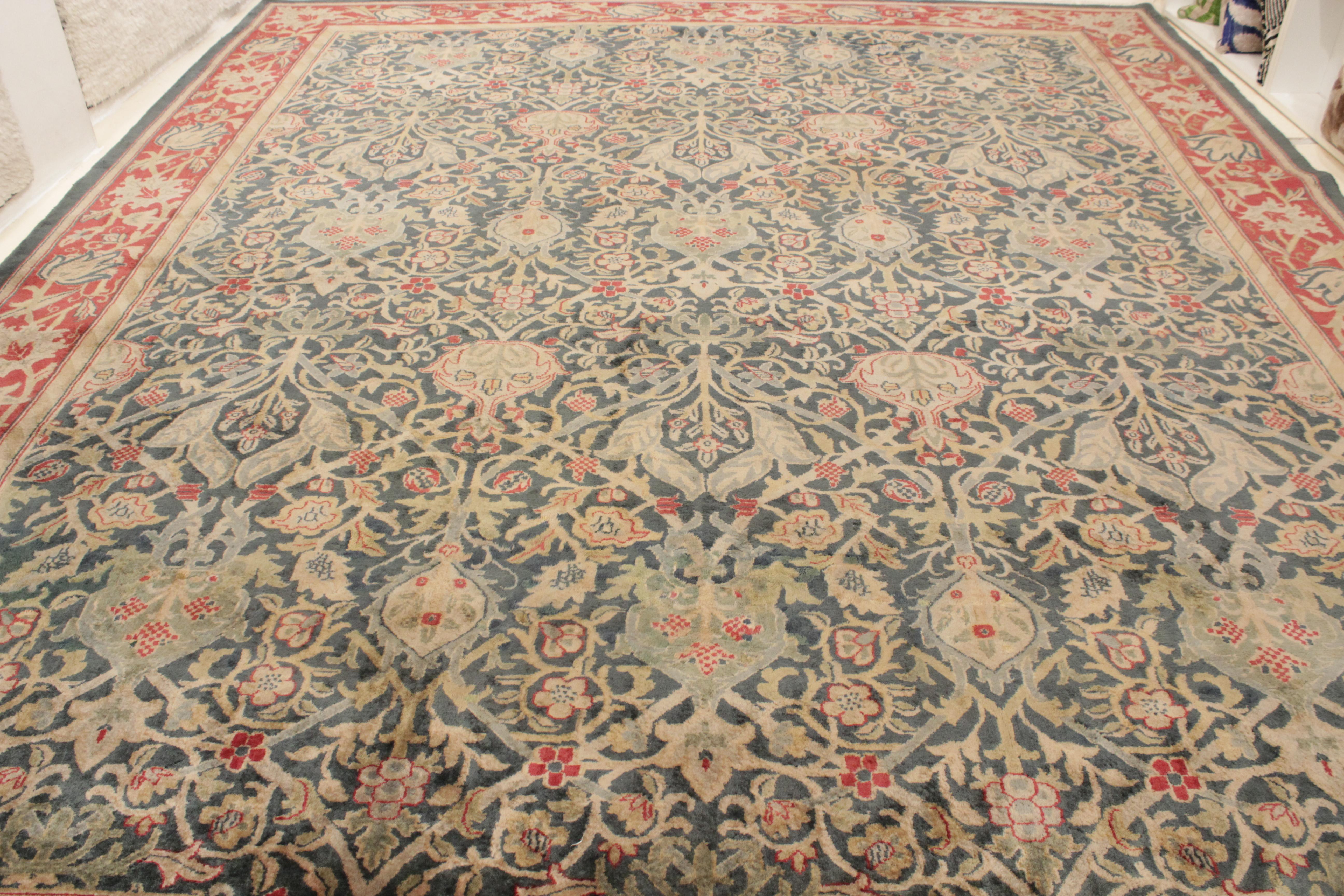 A fine antique Indian carpet woven with lustrous wool, distinguished by a forest green background densely embellished by an infinite repeat pattern of stylised palmettes and arabesques, taken from a very well known group of rugs known as the