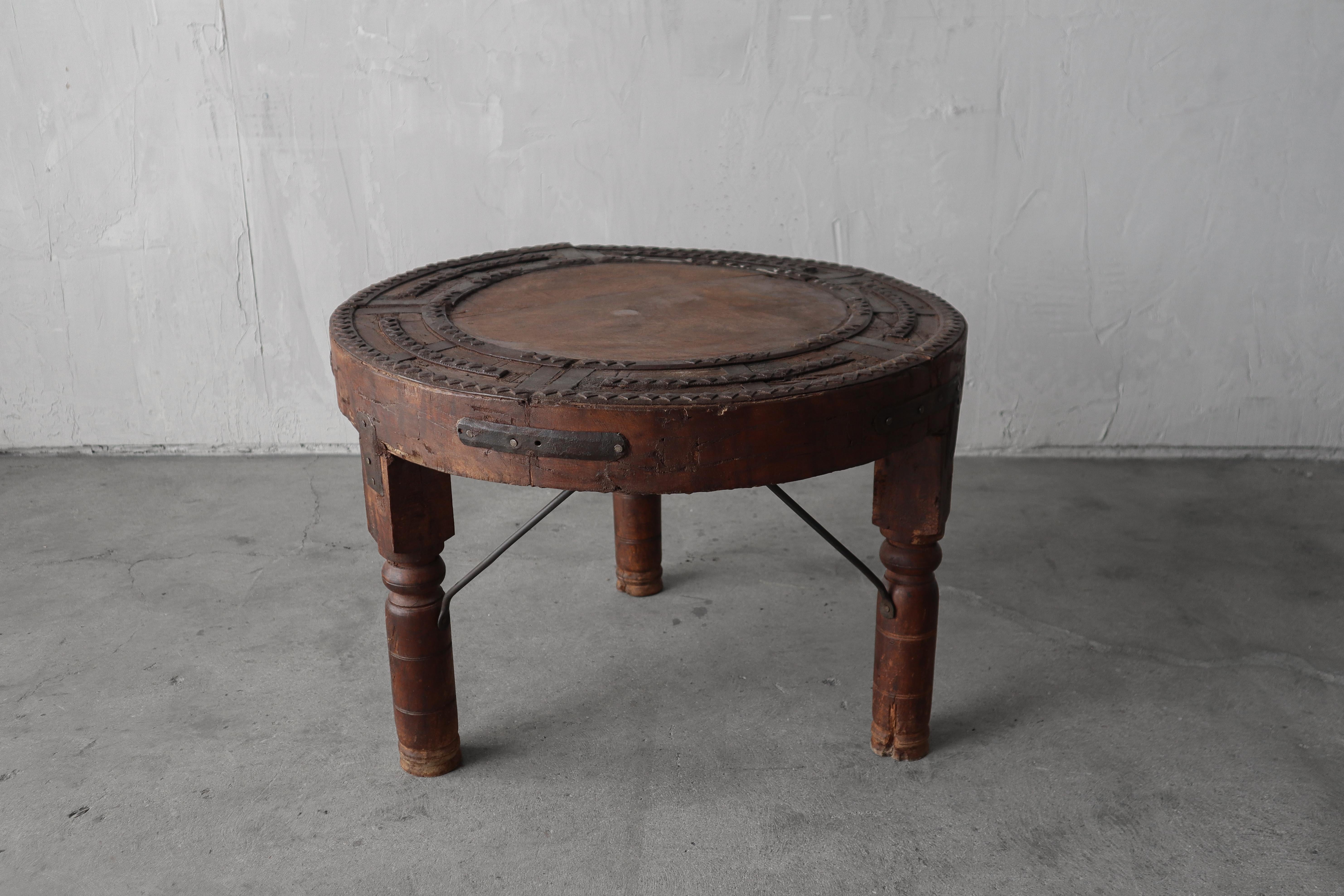 Great primitive handmade bullock cart wheel table.  Perfect accent piece for Wabi Sabi or any eclectic decor. 

Everything about this piece exudes age and character. The wood is beautifully patinaed.  One small missing piece of wood in the top. 