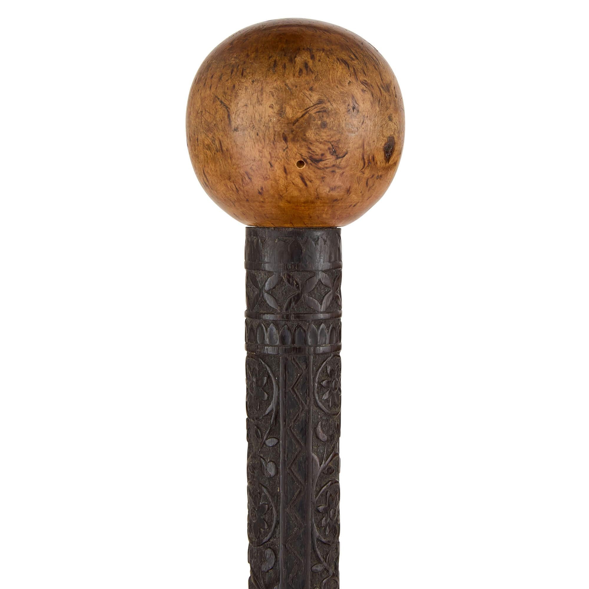 Antique Indian carved wood folk art walking stick  
Indian, Late 19th Century  
Height 82cm, diameter 6cm 

Handcrafted in late 19th century India, this remarkable folk art walking stick is a testament to the exceptional craftsmanship of independent