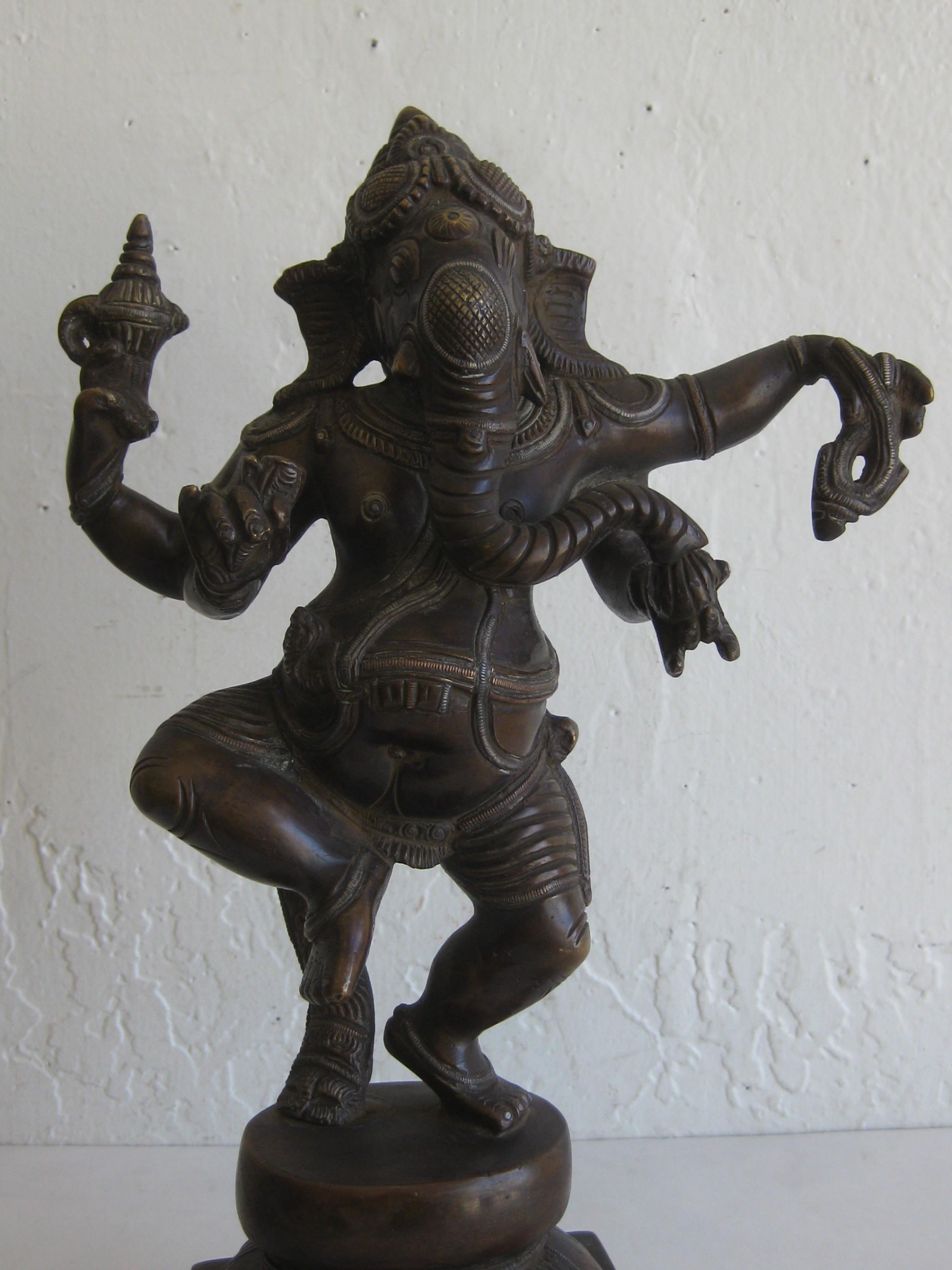 Fantastic antique Indian dancing four arm Lord Ganesha deity bronze statue sculpture. Very high quality bronze with awesome details. The bronze has a wonderful dark patina. In excellent original condition for its age. Measures 12 1/2