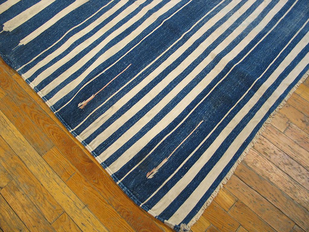 The majority of available cotton dhurries are blue and ecru two-tones, in a variety of sides. One of the most popular layouts shows nearly full-width eggshell stripes on a denim blue field, set within end panels of full-width narrow blue and white