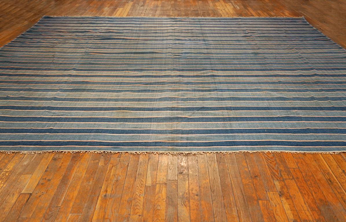 This good condition, all-cotton antique Indian tapestry-weave carpet shows side-to-side stripes of varying widths in blue tones. Square and oblong dhurries are available in up to giant sizes from our extensive inventory. The handmade character is