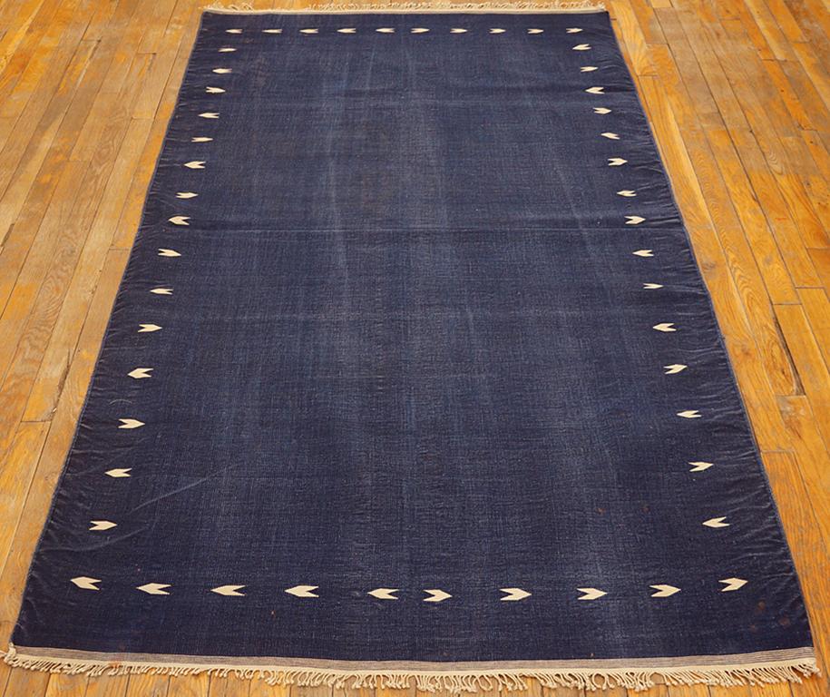 The whole scatter sized piece is a saturated dark blue, with the only ornament being off-white reversing little arrowheads making an implicit border. This antique with a truly intense palette is in very good condition, finely woven and certainly