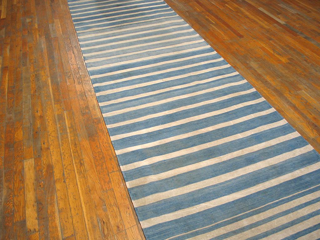 Dhurries come in all formats and most can be altered to fit a difficult space. This wide runner shows broad and narrow varying blue stripes. It can be narrowed to fit your space without losing any of its handmade character. Good condition. Measures: