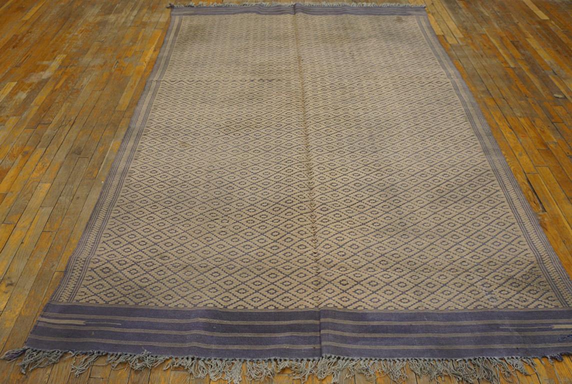 This is a really antique piece since dhurries over 100 years of age are truly rare. And it has a lozenge lattice pattern of weft-float beige yarns on a blue plainweave ground. Banded blue end panels. Striped and dotted side borders. Good condition.