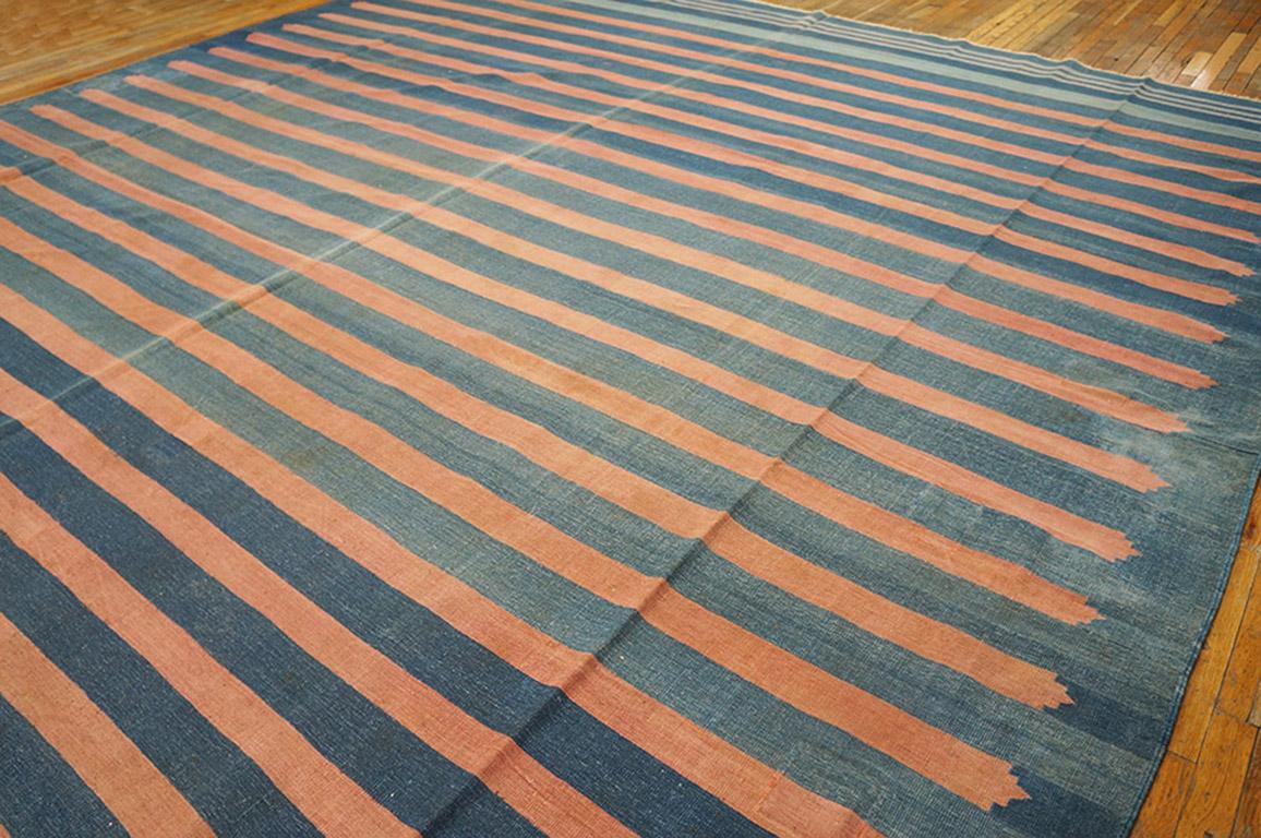 Actually an abrashed light to washed denim blue field, with chamfered pink partial width stripes. Narrow blue and ecru stripes decorate the end panels. Signed in one corner, all-cotton construction and antique in good condition.