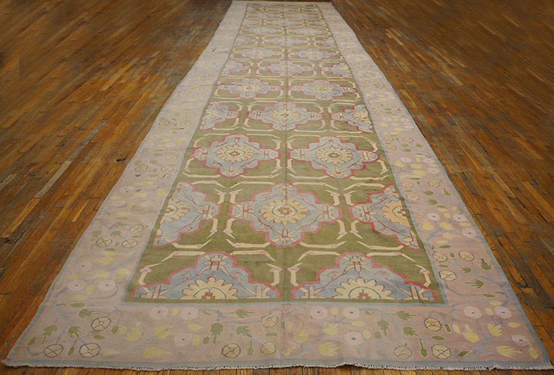 This antique all-cotton Indian flat-weave shows a grass green field with one central and two half side columns of pale blue lobed crosses with central pale salmon rosette centres, framed by a wide equally ice blue border with a bud and rosette