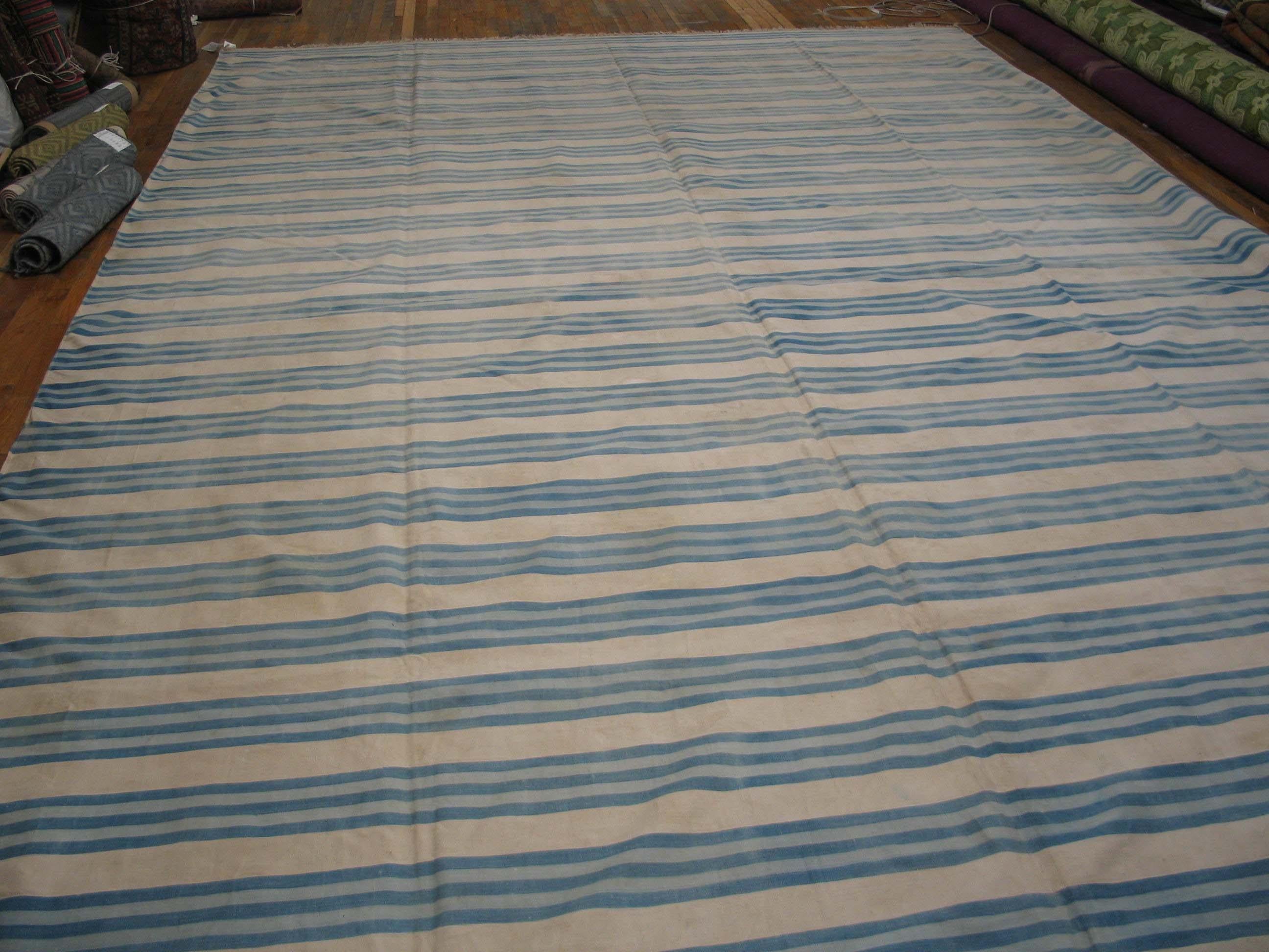 The overall pattern of triple light blue lines fades in and out, giving a hand washed character to this softly bitonal piece emphasizing the intermediate ecru stripes. Almost infinitely size adjustable. Good condition. All cotton construction.
