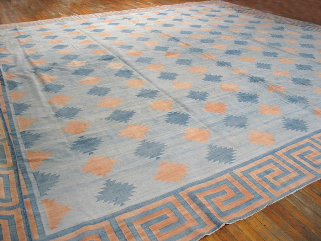 An abrashed, but very light sky blue ground supports columns (or color diagonals) of ashik medallions in denim blue and a straw-to-rust, also abrashed. A square wave fret border in light orange-rust and denim blue frames this good condition, older