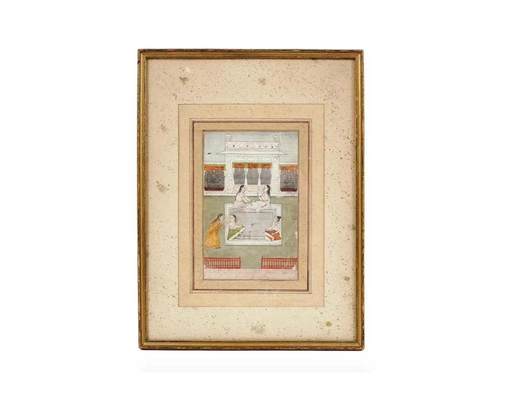 An antique Indian miniature painting. Early Mughal Empire period, 16th to 17th century. The artwork depicts a harem scene, semi-nude women bathing in the pool. Fine detail work. Beige mat, golden frame. Islamic Oriental Graphic Art For Collectors,