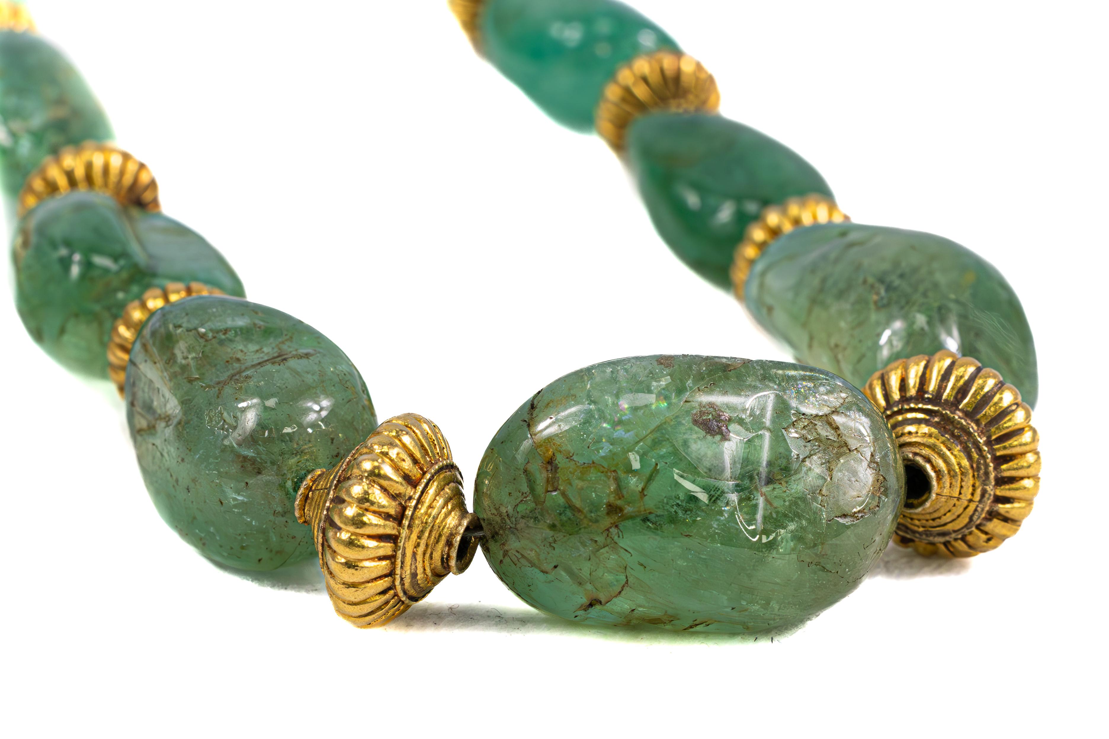 Title: Antique Indian Gold and Emerald Bead Necklace, Circa 1900

Description: A striking piece of Indian heritage, this antique necklace features 15 rich green emerald beads of remarkable size, totaling approximately 225.00 carats. Each bead is