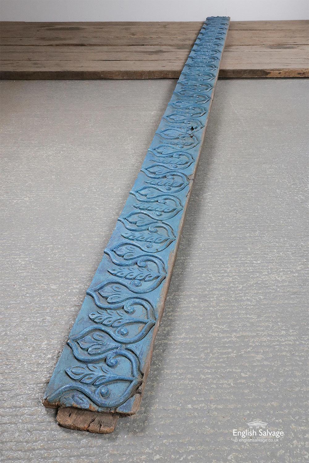 Antique hand carved hardwood panel, reclaimed from Indian. The front face of the panel has a repeating flower and leaf decoration and has been painted blue. There are some dings and splits commensurate with age.