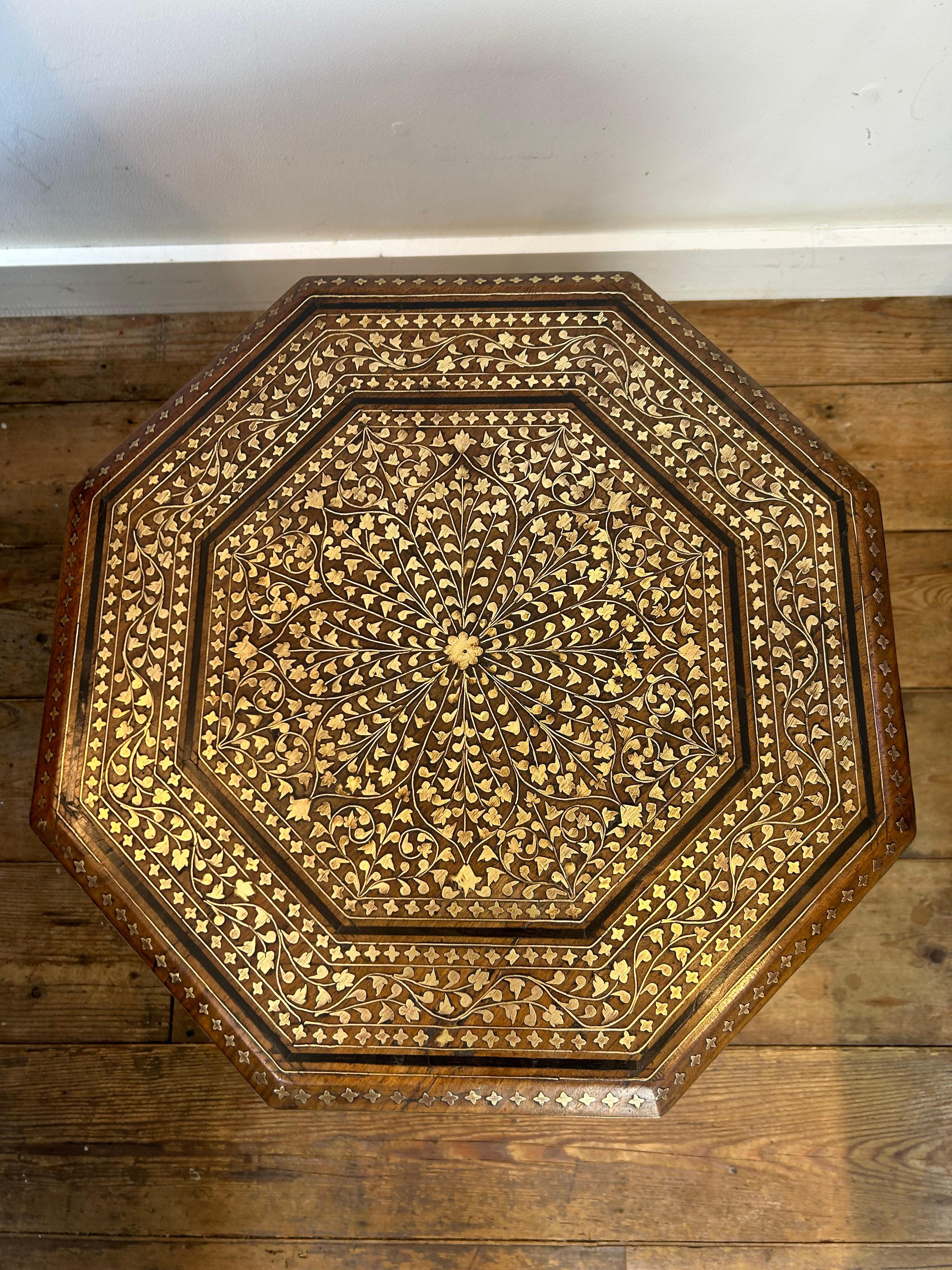 Hoshiarpur hexagonal table circa 1890 profusely inlayed with brass foliage and barbers pole decoration to the legs, the table is in very good condition with no missing inlays and a pleasing light colour.