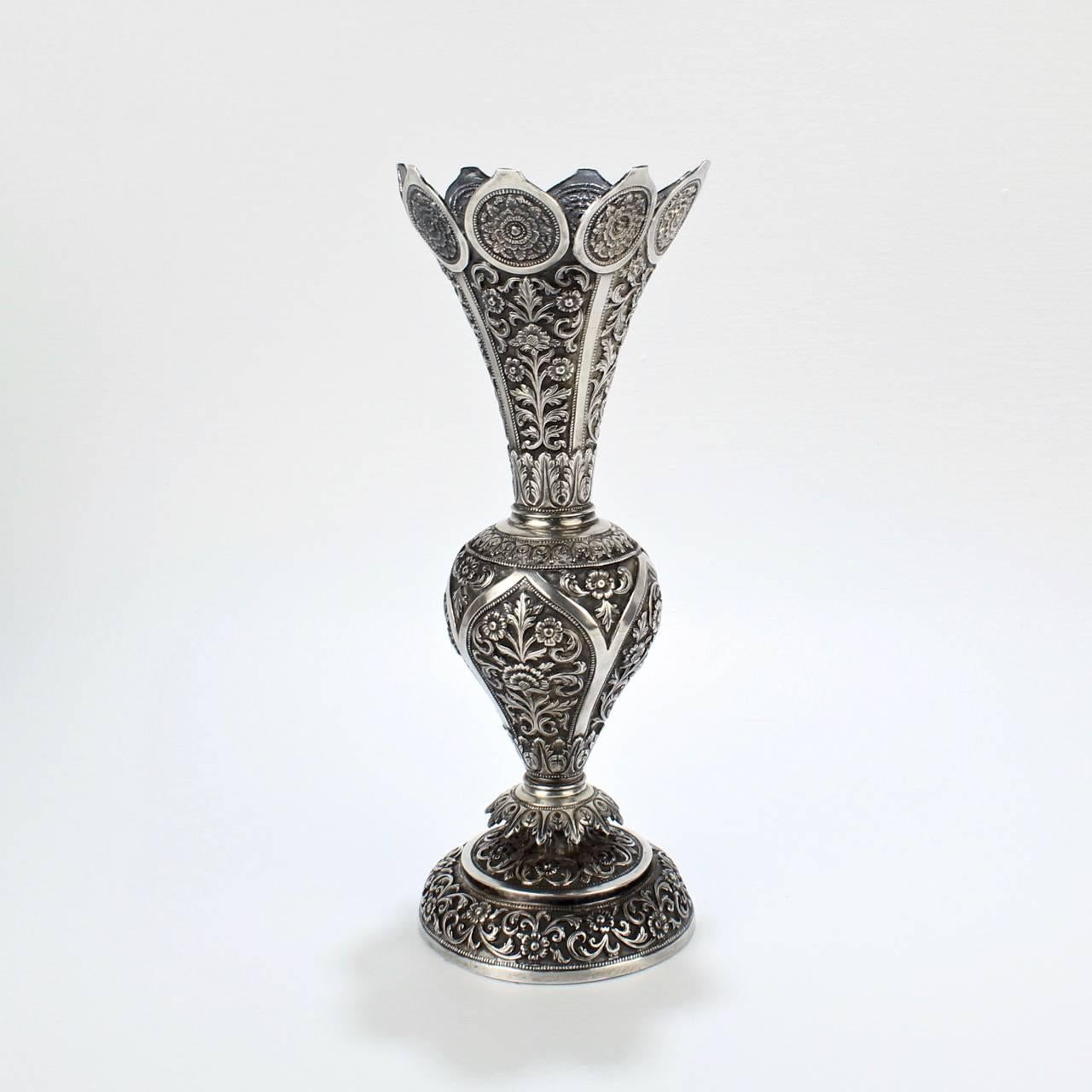 A good antique Kutch silver vase from the famous Oomersi Mawji & Sons workshops.

The workshop was located in Baroda (now Vadodara in the Western state of Gujarat) and was the source of some of the finest 19th and early 20th century silver that