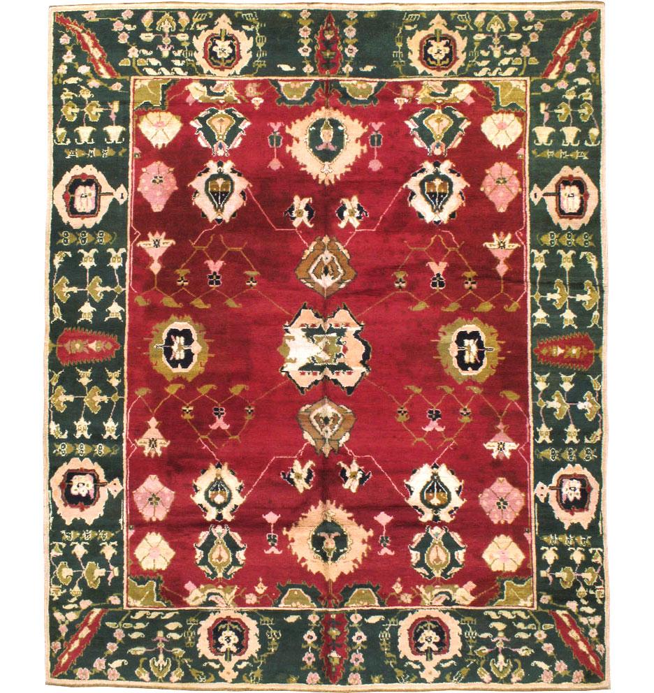 A vintage Indian Lahore room size rug handmade during the mid-20th century with a large scale pattern over a maroon field and enclosed by a wide green border.

Measures: 7' 11