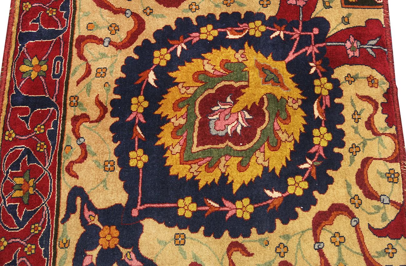 This is a border fragment of a Lahore Carpet that was woven in Norther India circa 1900. The design of this rug is from early Safavid carpets from 16th century Persia. The design is a combination of Shah Abbas palmettes that originate from Persia