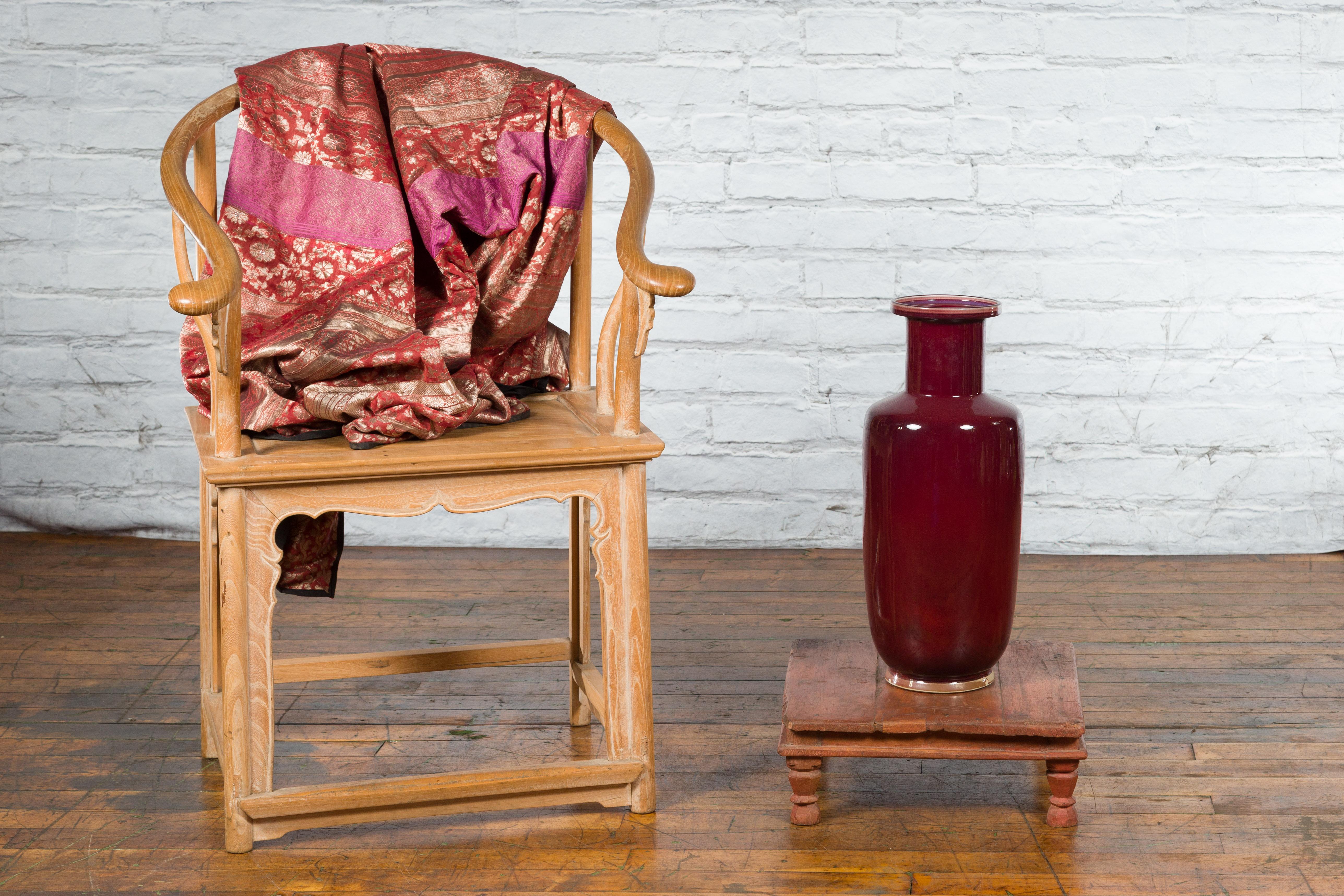 An Indian antique low wooden prayer table from the early 20th century, with carved legs. Created in India during the early years of the 20th century, this wooden prayer table features a square planked top sitting above a recessed apron. Four small