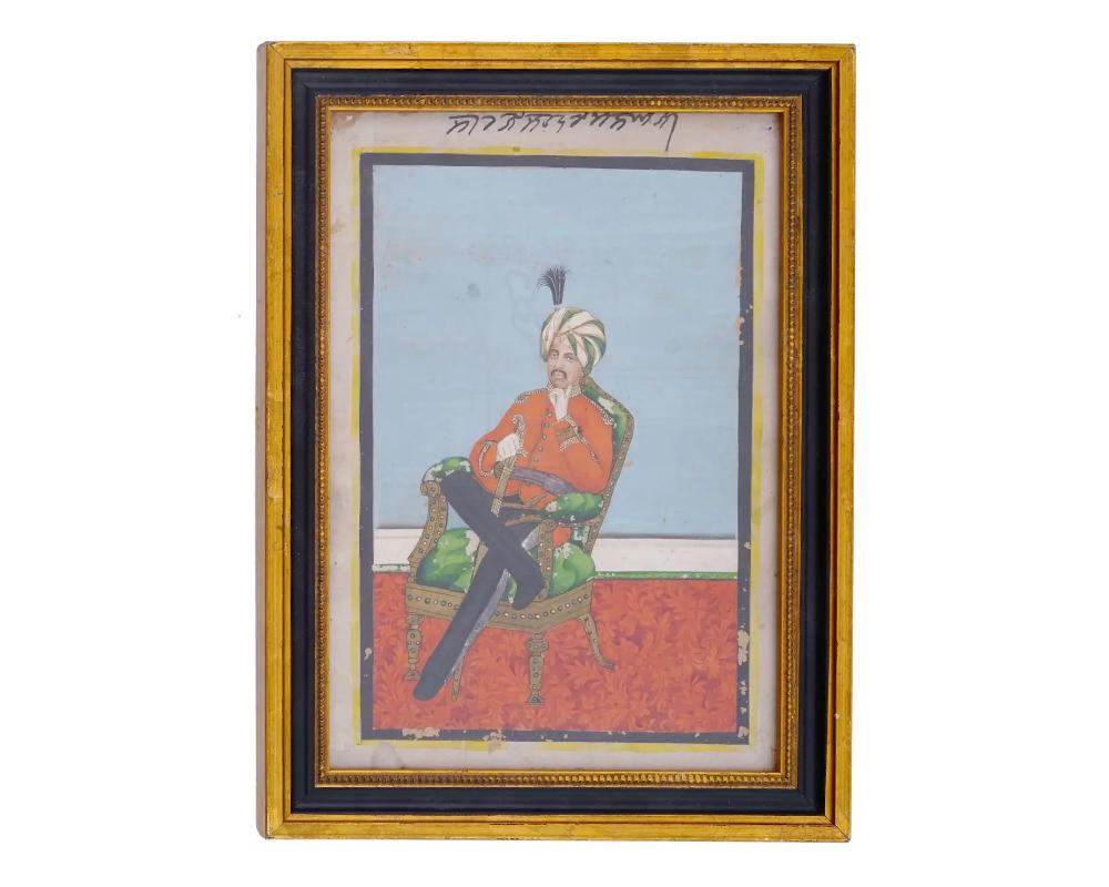 An antique Indian miniature painting portraying a seated sultan holding a sword. Miniature paintings like this one are renowned for their intricate detailing, vibrant colors, and storytelling elements. In this artwork, the seated sultan is depicted