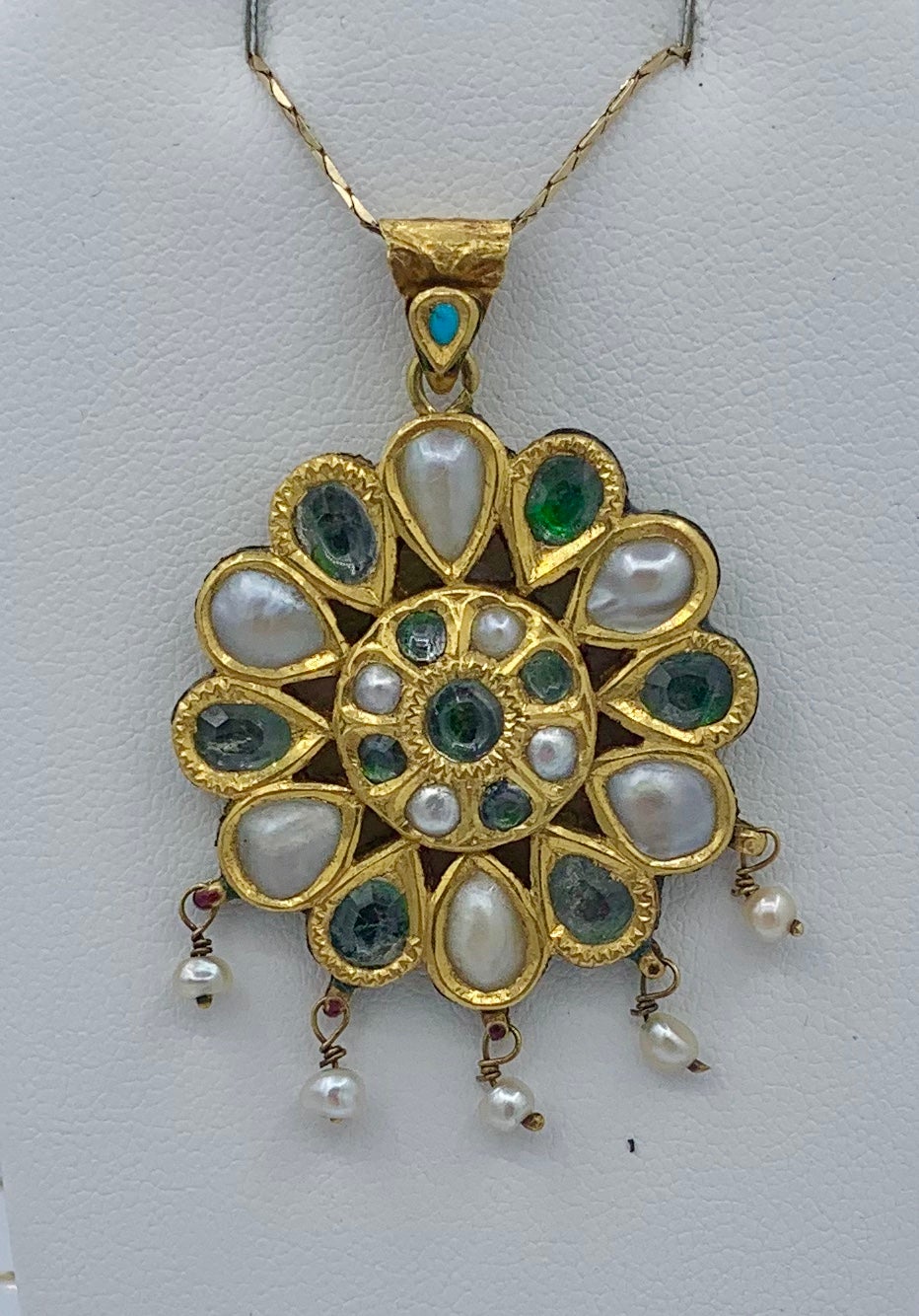 This is a wonderful antique Indian Mughal Jeweled Pendant in 22 Karat Gold set with gorgeous Topaz gems with Pearls in a classic medallion design with exquisite Enamel bird and flower decoration on the reverse.  This is an early antique pendant. 