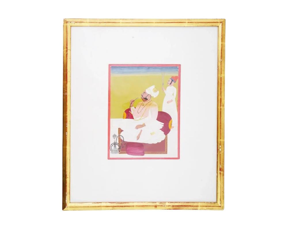 An antique Indian Mughal Empire miniature painting from Jodhpur, executed in pigments and adorned with gold paint on paper. Portrays a seated raja and a standing servant holding a fly-whisk. These Mughal miniatures are renowned for their intricate