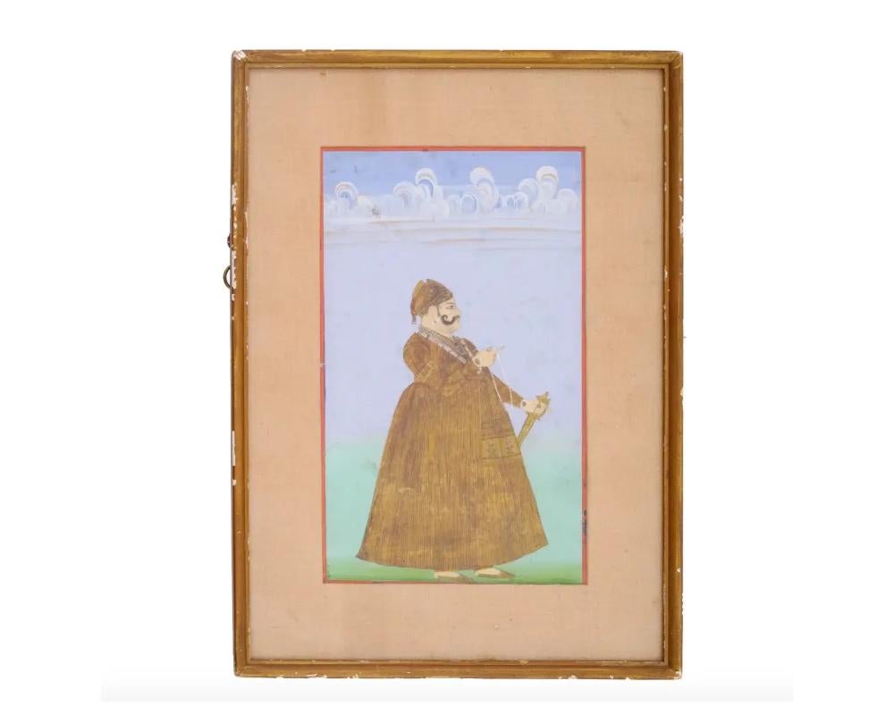 An antique Indian Mughal school painting depicting a nobleman, executed in opaque colors on paper, represents an exquisite example of Mughal miniature artistry. Mughal miniatures are renowned for their meticulous details, vibrant pigments, and