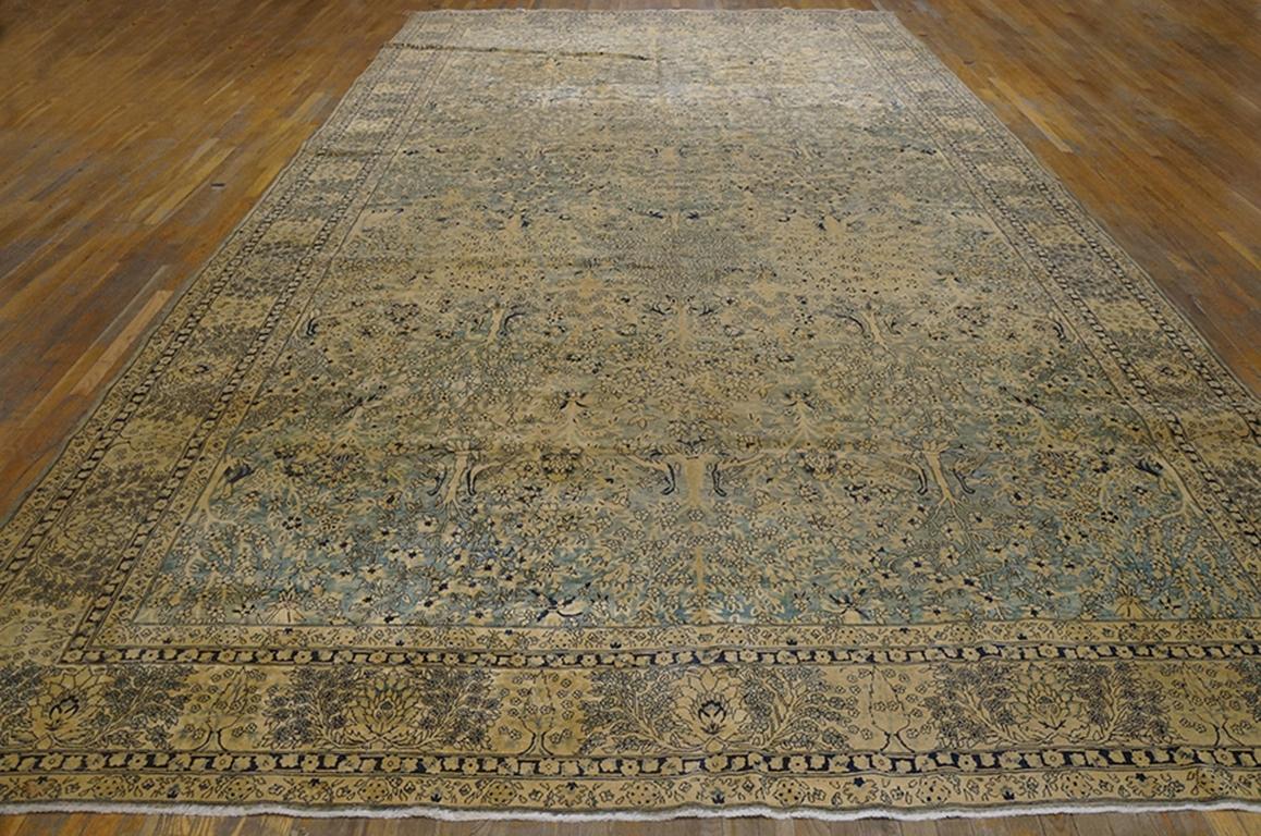 The moderately finely woven northern Indian “Laristan” carpet features a field abrashing from cream to pale grey with a one-way pattern of flowering trees closely flanked by pairs of birds. The sand border shows cypresses, floral sprays and