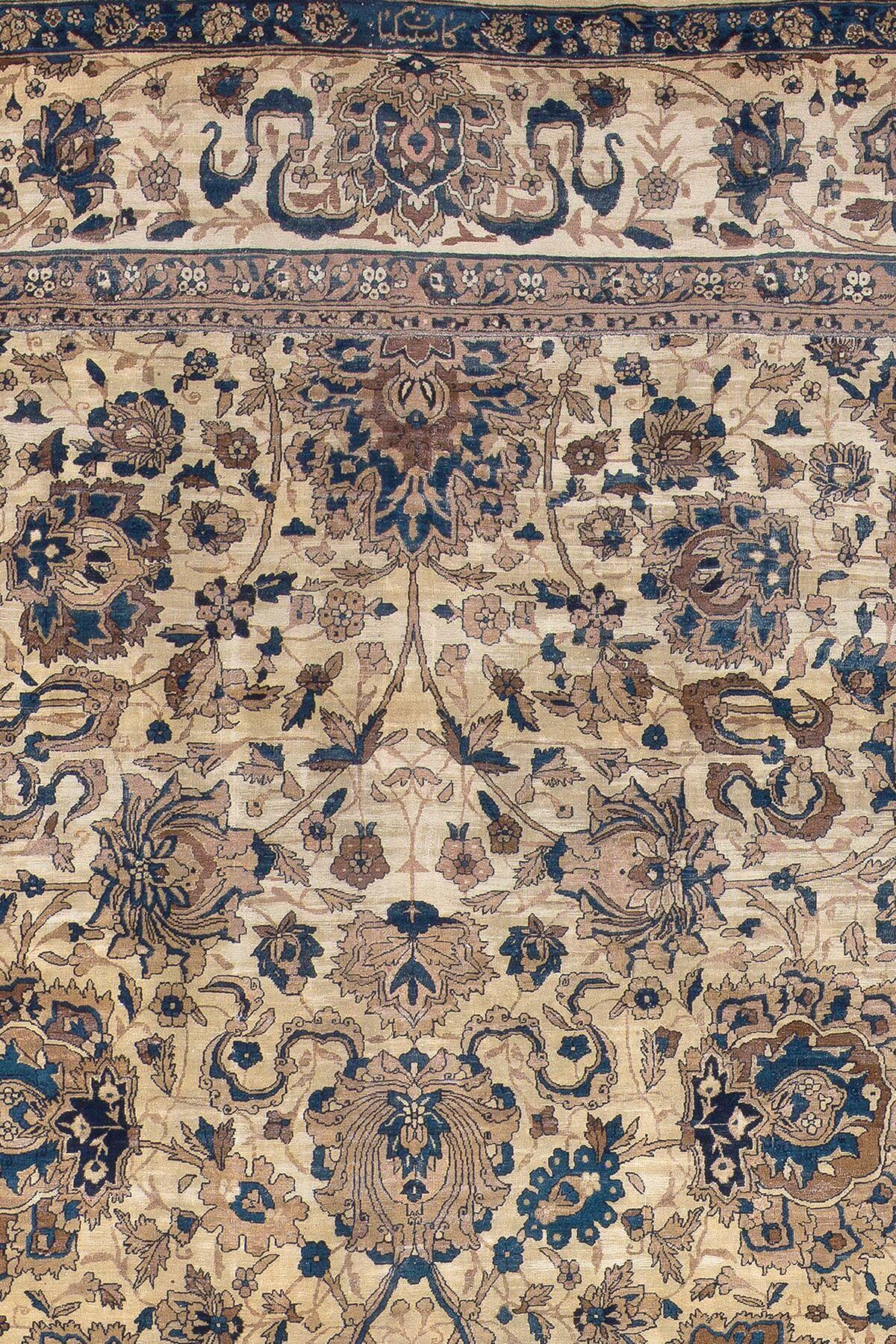 A palace size formal Indian rug containing an ivory field with accents of denim blue. Finely woven in a large Indian factory back in the latter stages of the 19th century.

14'6'' x 26'9''