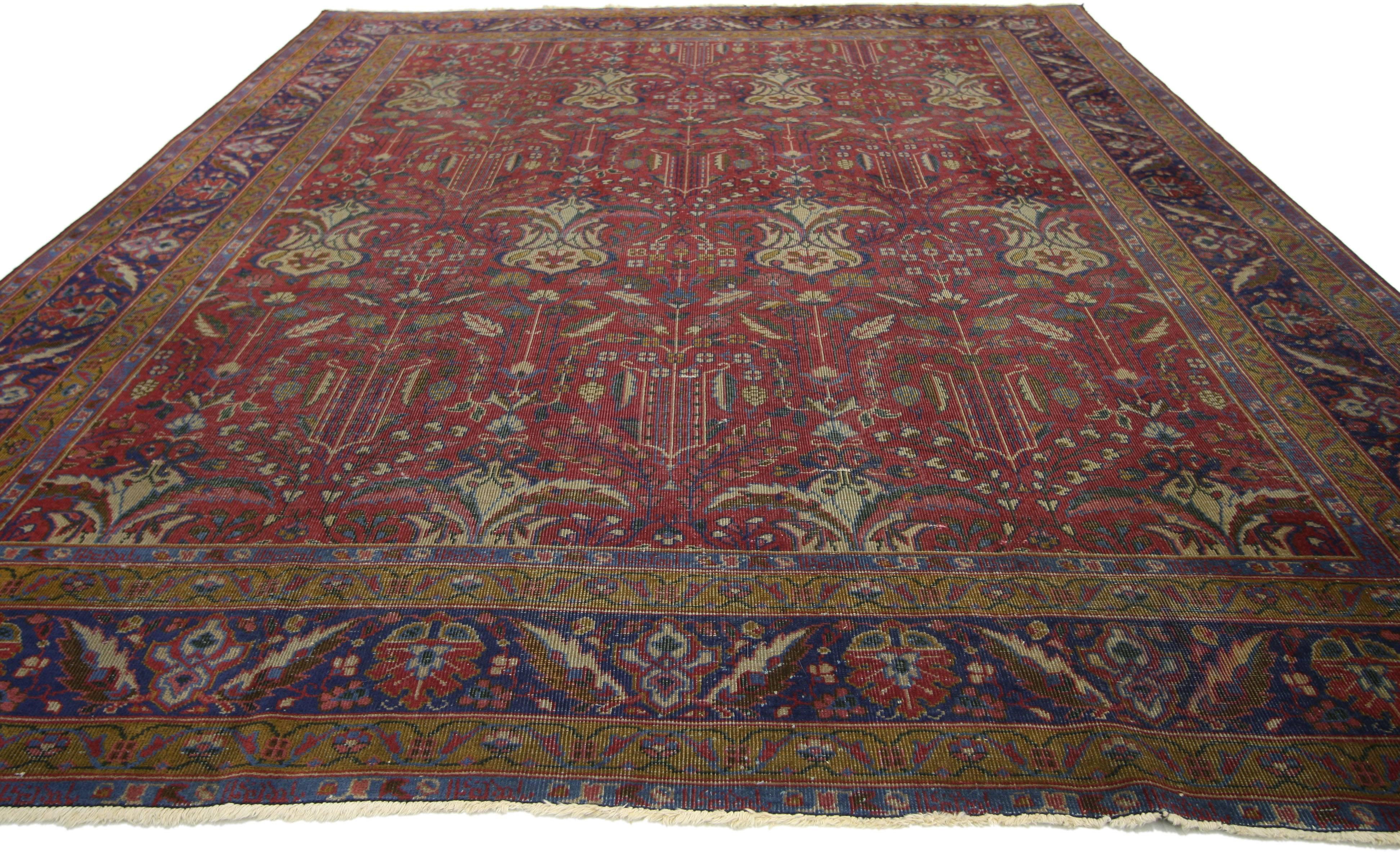 72879, antique Indian rug with traditional Victorian style and Mughal design. This hand knotted wool antique Indian rug features an all-over floral pattern spread across an abrashed ruby red field. Drawing inspiration from traditional Mughal