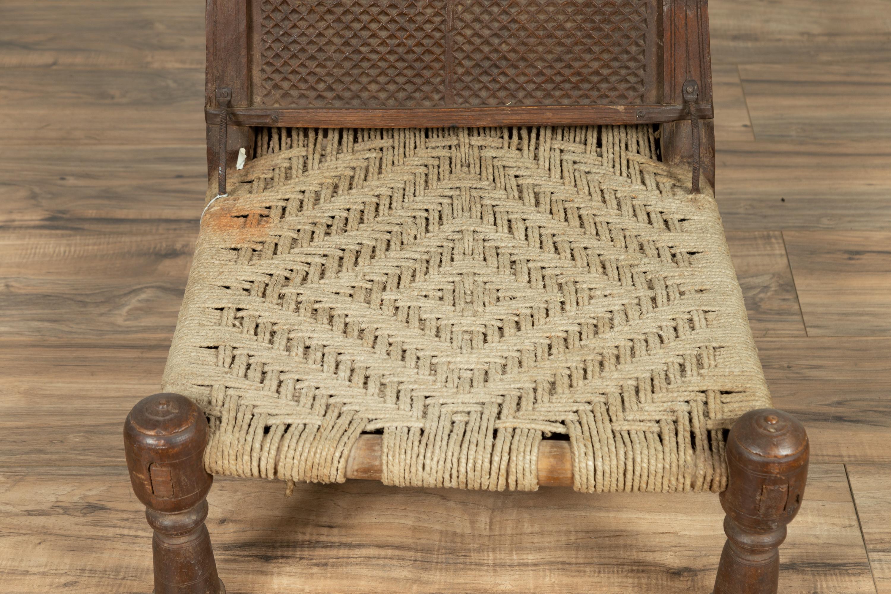 Hand-Carved Antique Indian Rustic Low Seat Wooden Chair with Carved Rosettes and Twine Seat For Sale