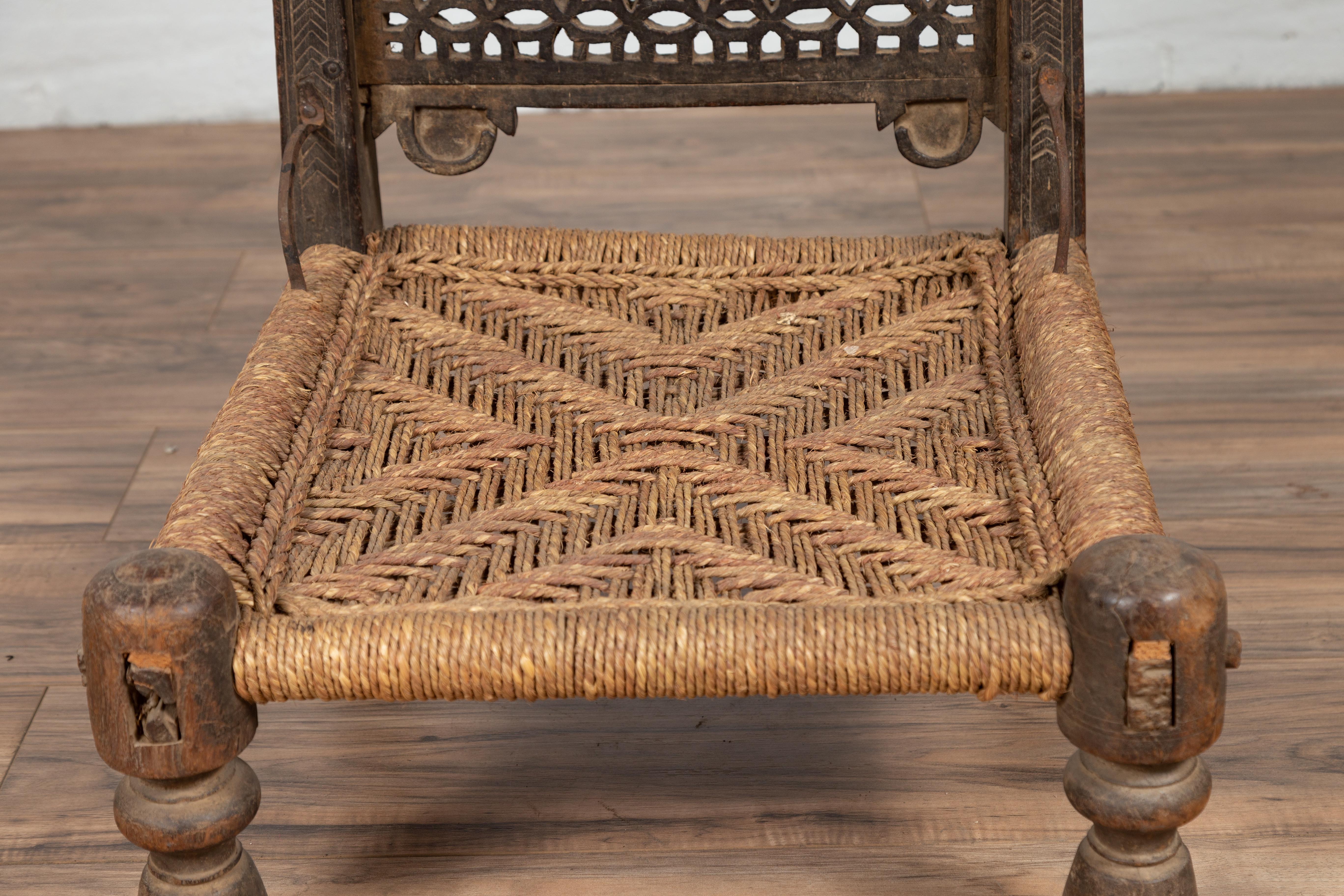 Antique Indian Rustic Low Seat Wooden Chair with Fretwork Accents and Rosettes For Sale 4
