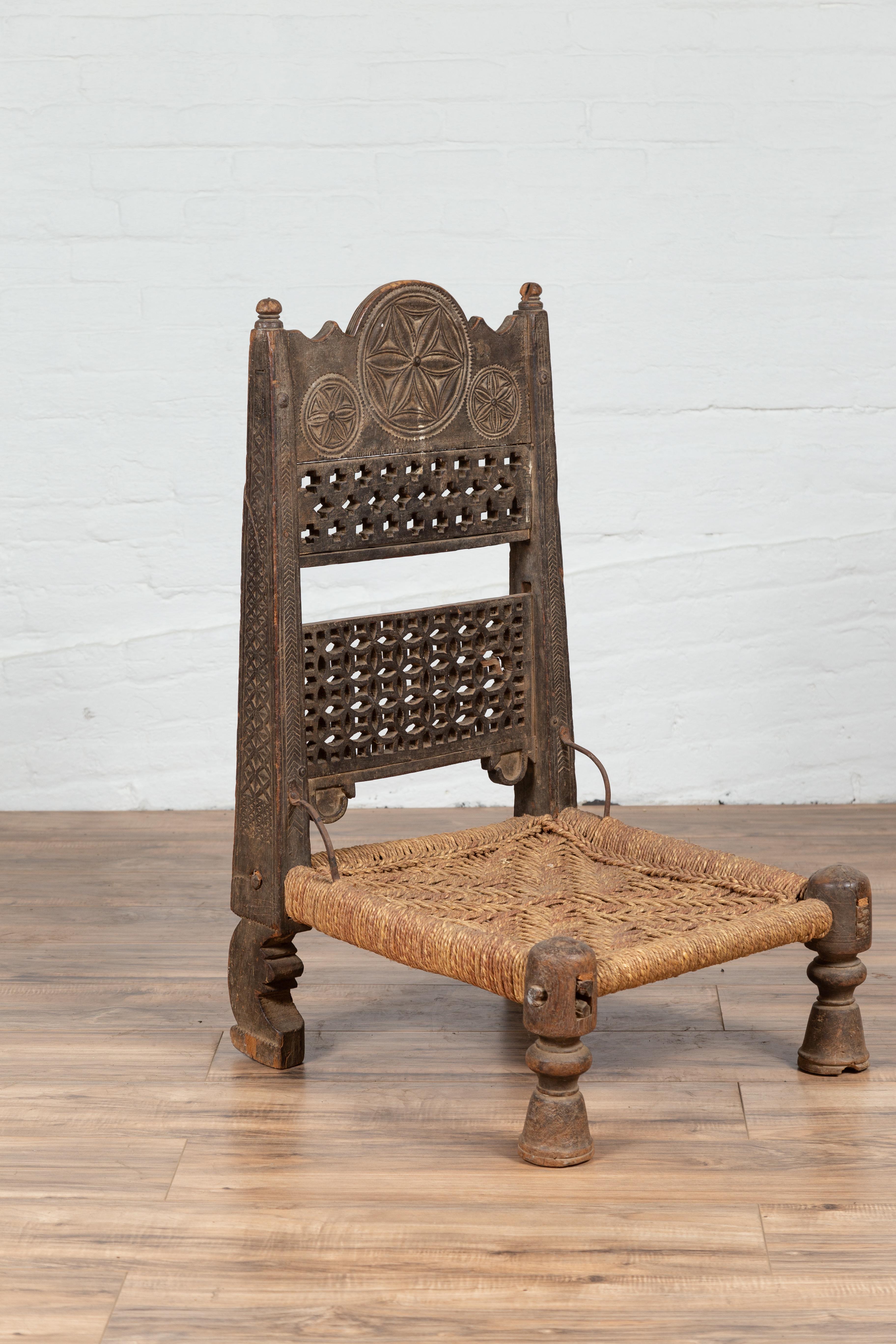 Twine Antique Indian Rustic Low Seat Wooden Chair with Fretwork Accents and Rosettes For Sale