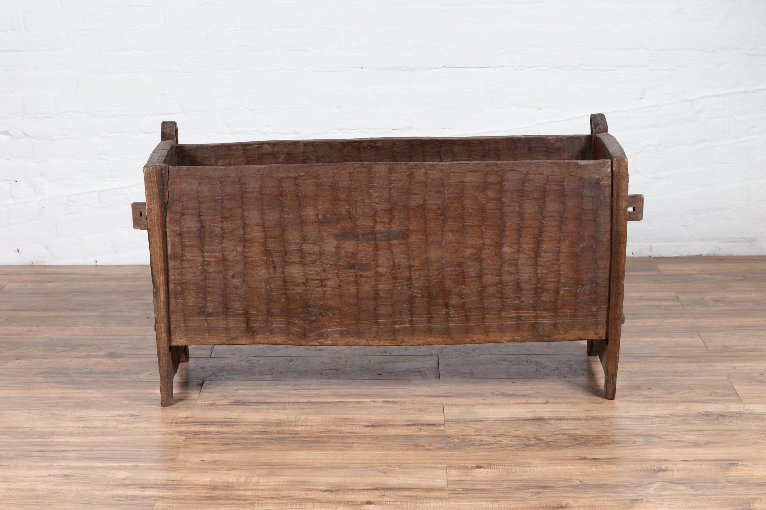 An antique Indian rustic wooden planter box from the early 20th century with nicely weathered appearance. Born in India during the early years of the 20th century, this wooden planter box charms our eyes with its rustic chiseled appearance and