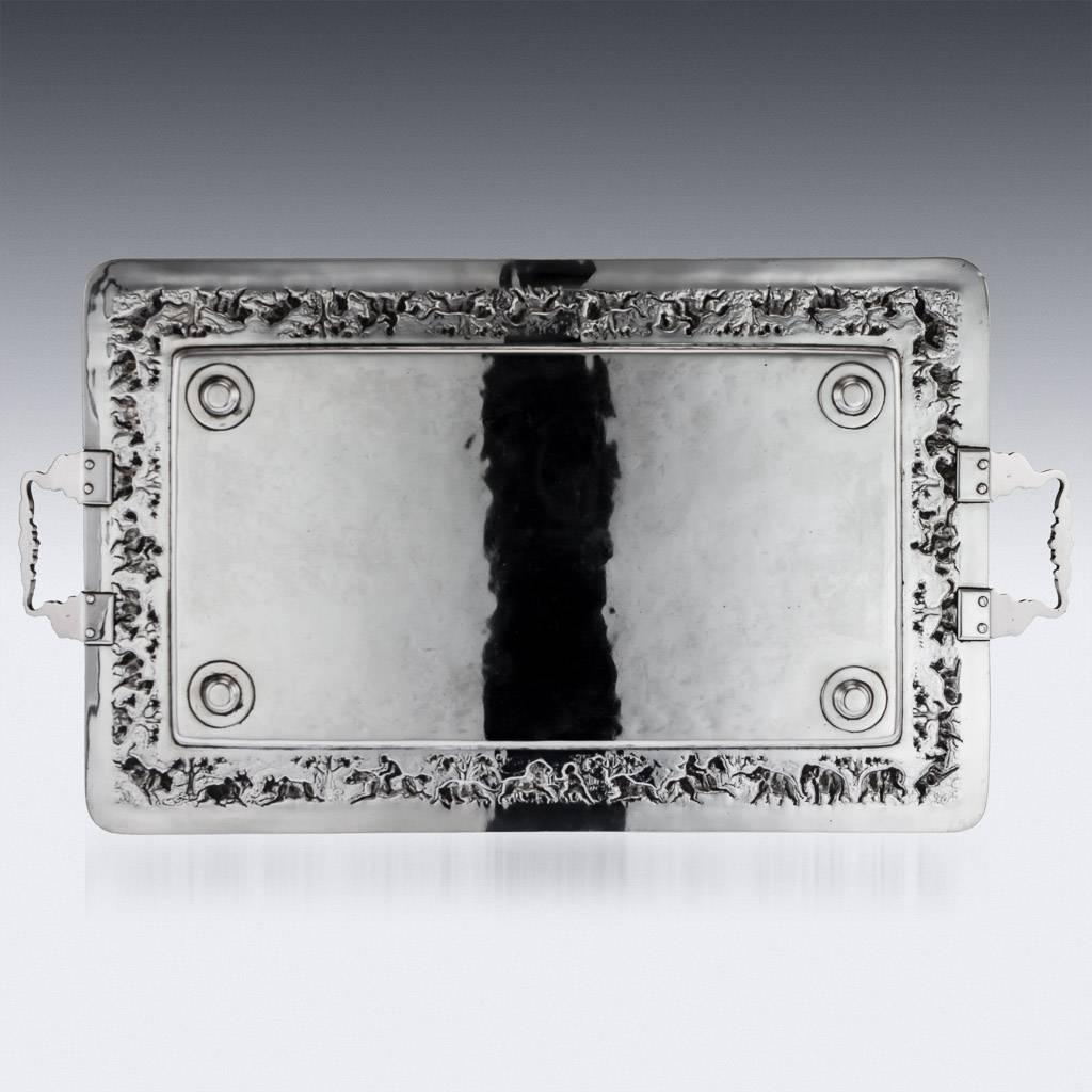 Antique early-20th century Indian Colonial solid silver repousse large tea tray, the border is profusely and beautifully repousse' decorated with hunting scenes in landscape, beaded boarder, the twin handles realistically modelled as elephants heads