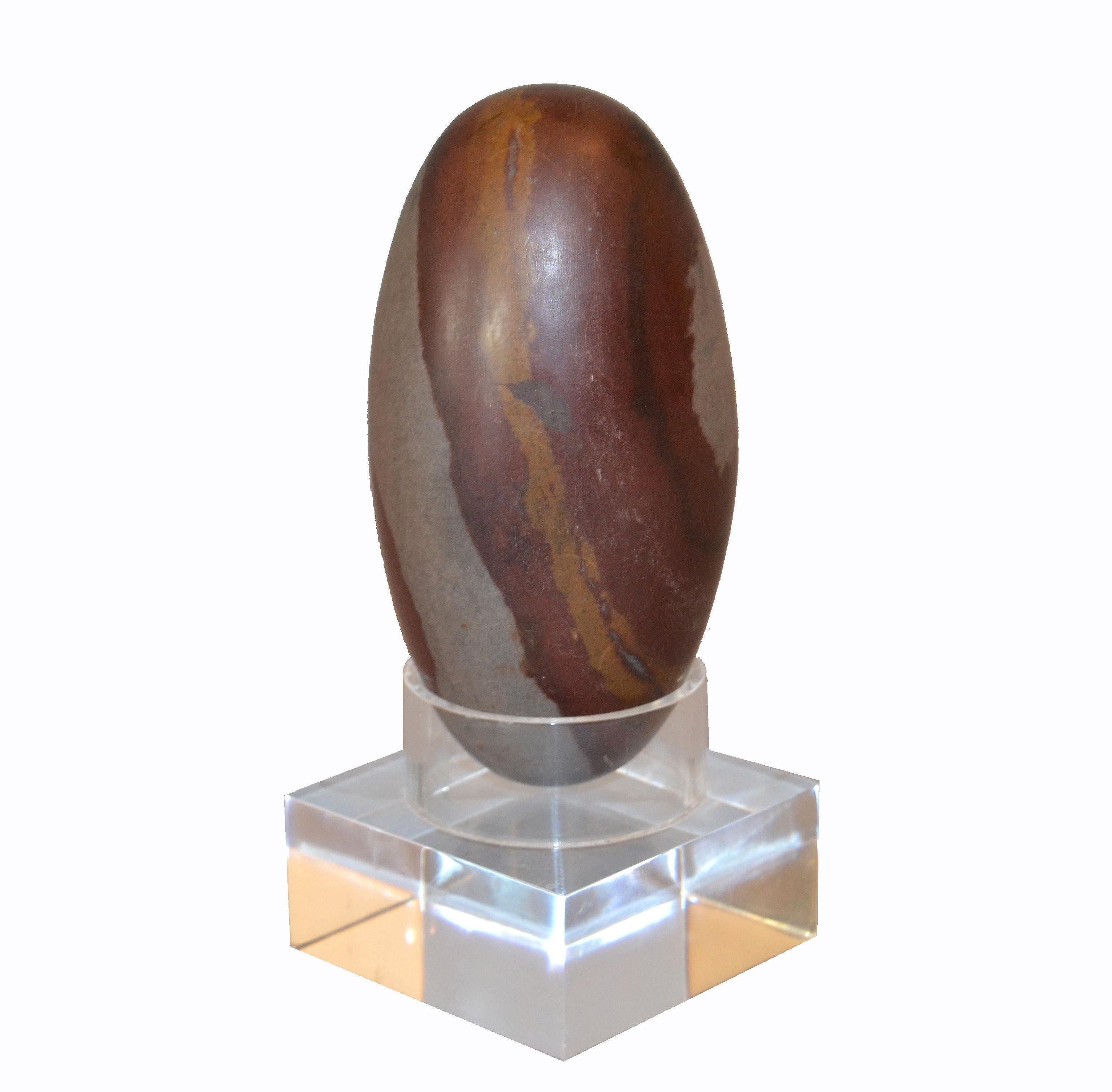 Antique Indian Tantric Shiva Lingam Stone presented on a clear Lucite Stand.
Please not the unique grain pattern of the stone.
Simply Lovely and a great gift for this Holiday Season.