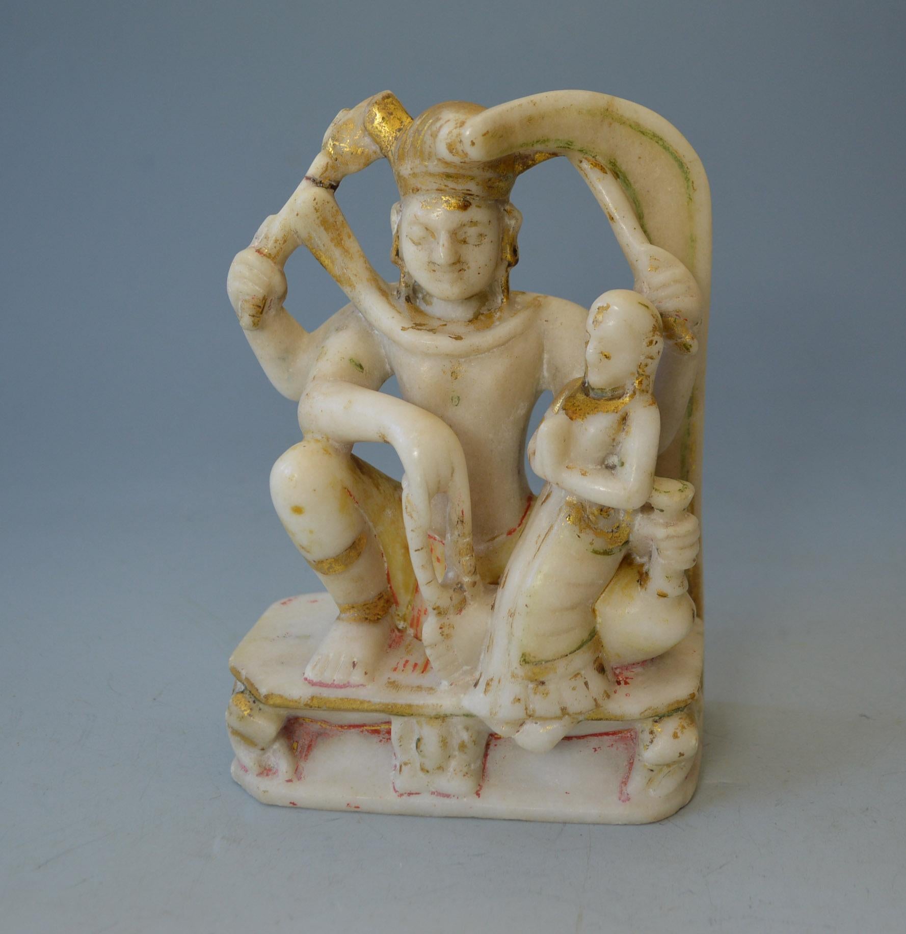 Antique Indian Votive marble sculpture Shiva Parvati.
Carved marble shrine figurative group of Shiva with consort Parvati.
White marble with remains of applied gold and red pigments.
Period 19th Century and earlier.

