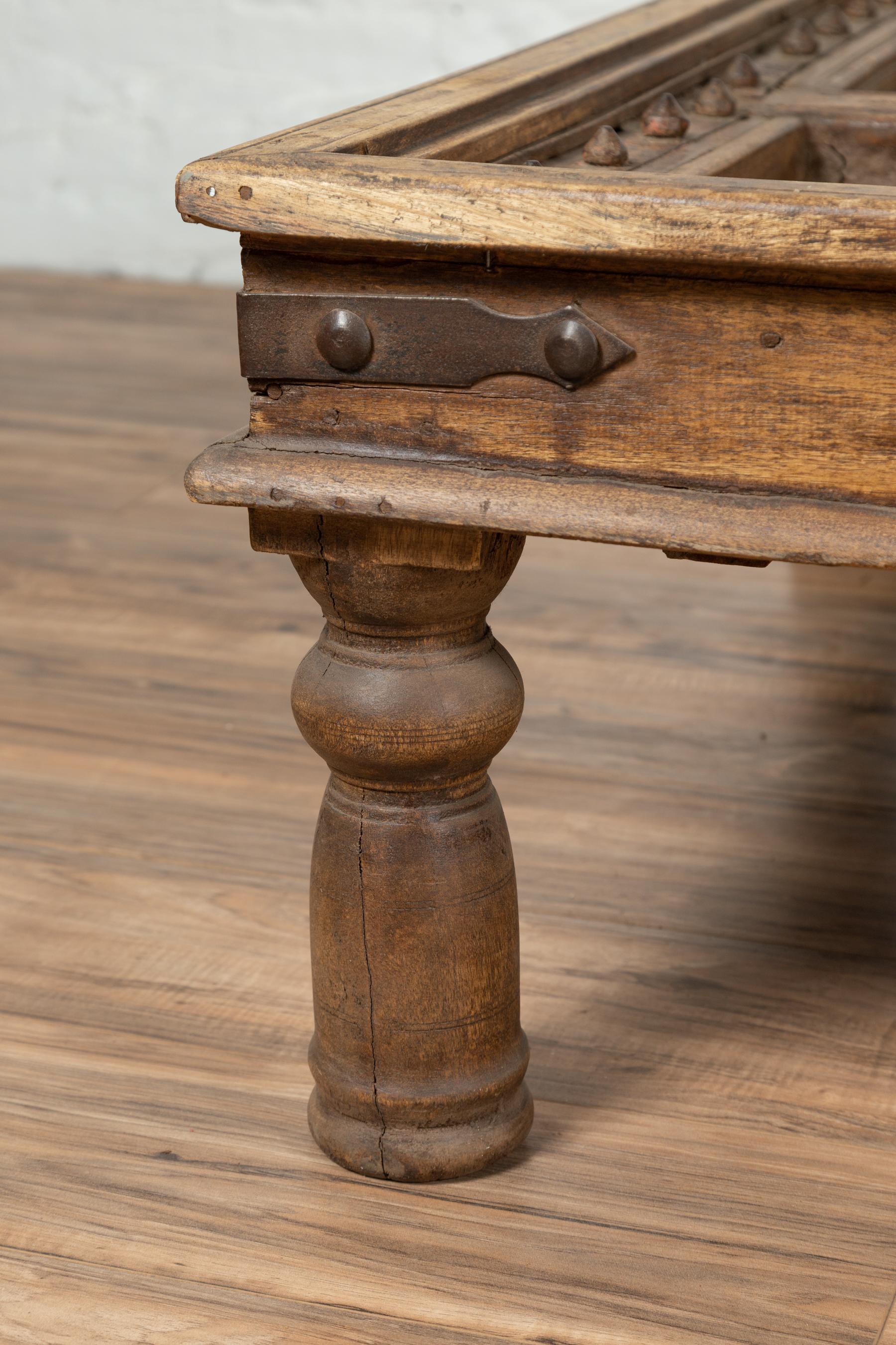 Turned Antique Indian Wooden Palace Door Made into a Coffee Table with Iron Braces