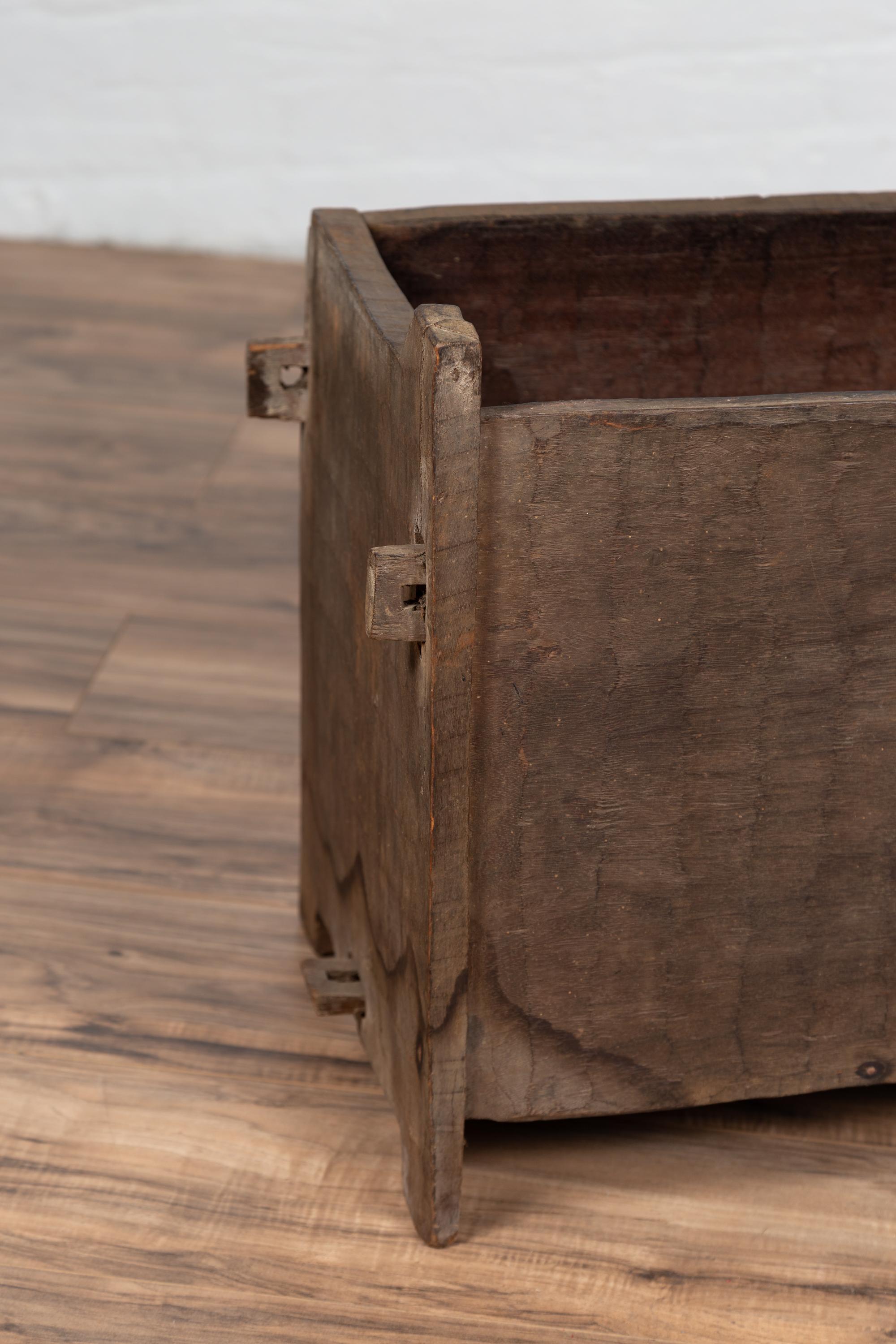 An antique Indian wooden planter box from the early 20th century with nicely weathered appearance. Born in India during the early years of the 20th century, this wooden planter box charms our eyes with its rustic appearance and irregular shape.
