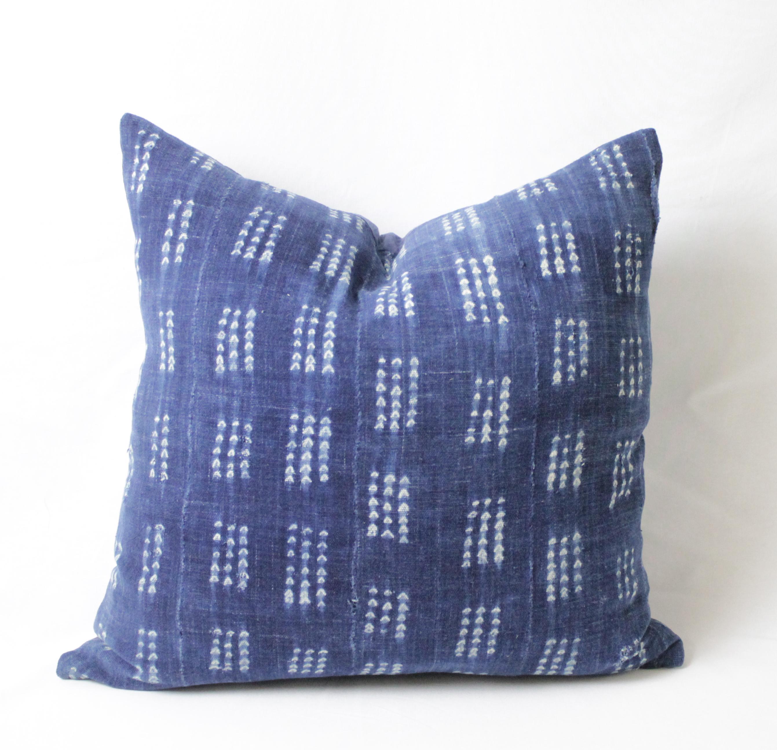 Antique indigo blue batik accent pillows custom made in our studio from vintage African mud cloth fabrics. The fronts of the pillows are in an antique batik fabric, very soft and nubby, the backside are finished in an indigo blue linen, with hidden
