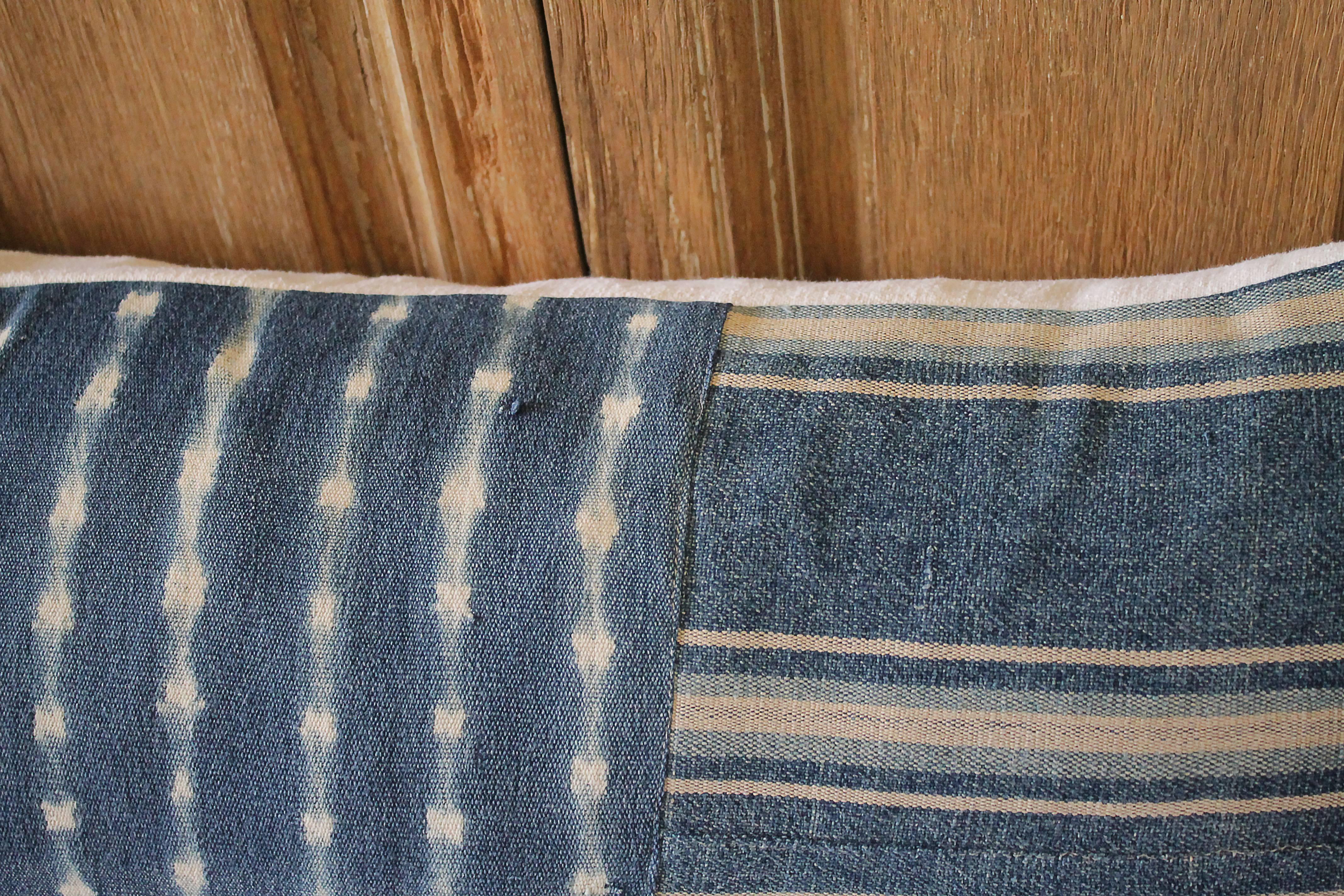 Custom pillow made from antique textiles by Full Bloom Cottage. Antique indigo blue Batik lumbar pillow with down insert and hidden zipper closure. Back side of the pillow is finished in an antique French linen in natural.
Measures 13 x 30.