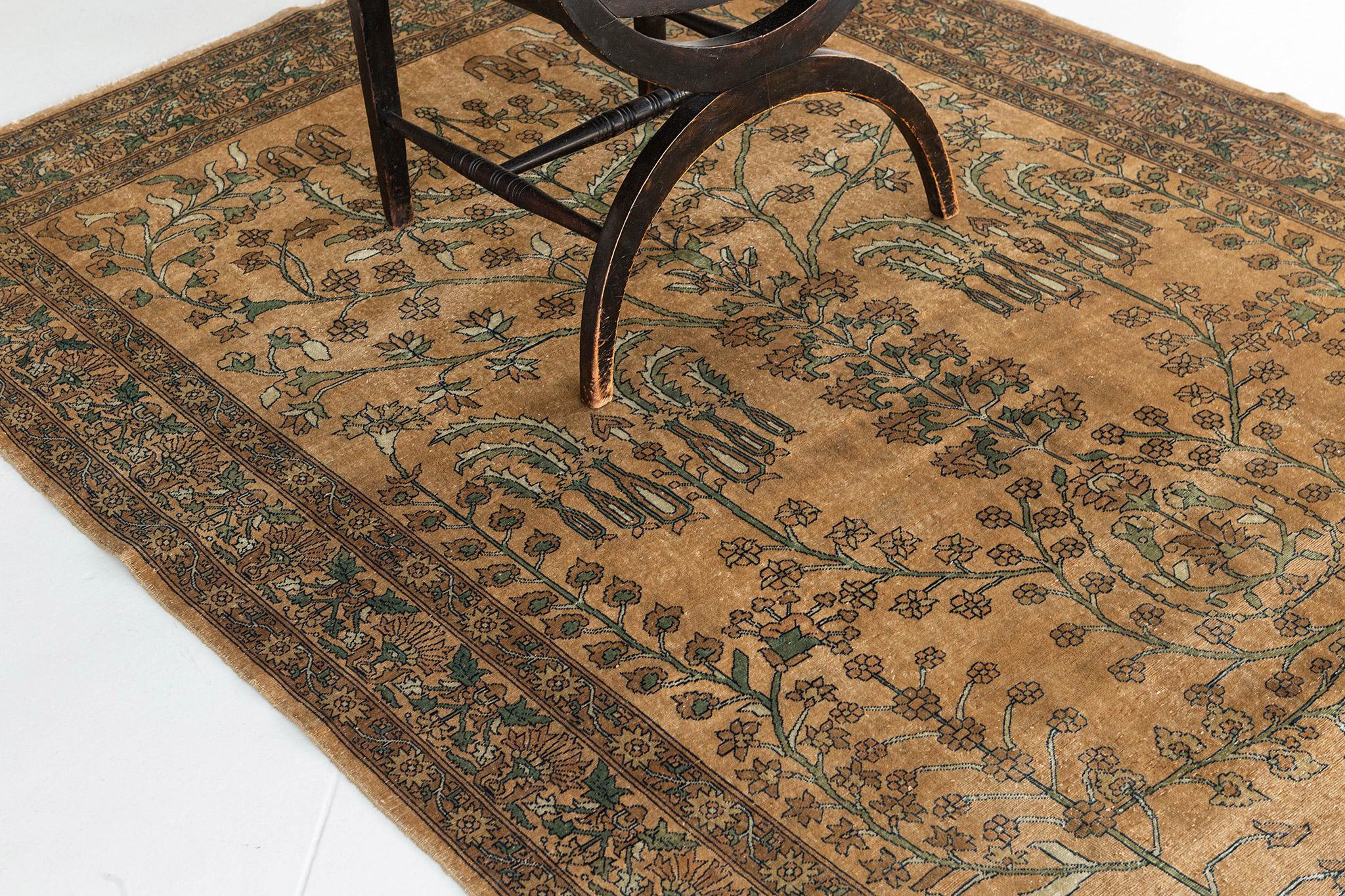 A glorious and dramatic Indo Agra rug features the spiraling vines and florets. Known for their unique palette of color, nature schemes are flaunted. This masterwork of art gives a light and ethereal appearance which is beautiful and stunning in any