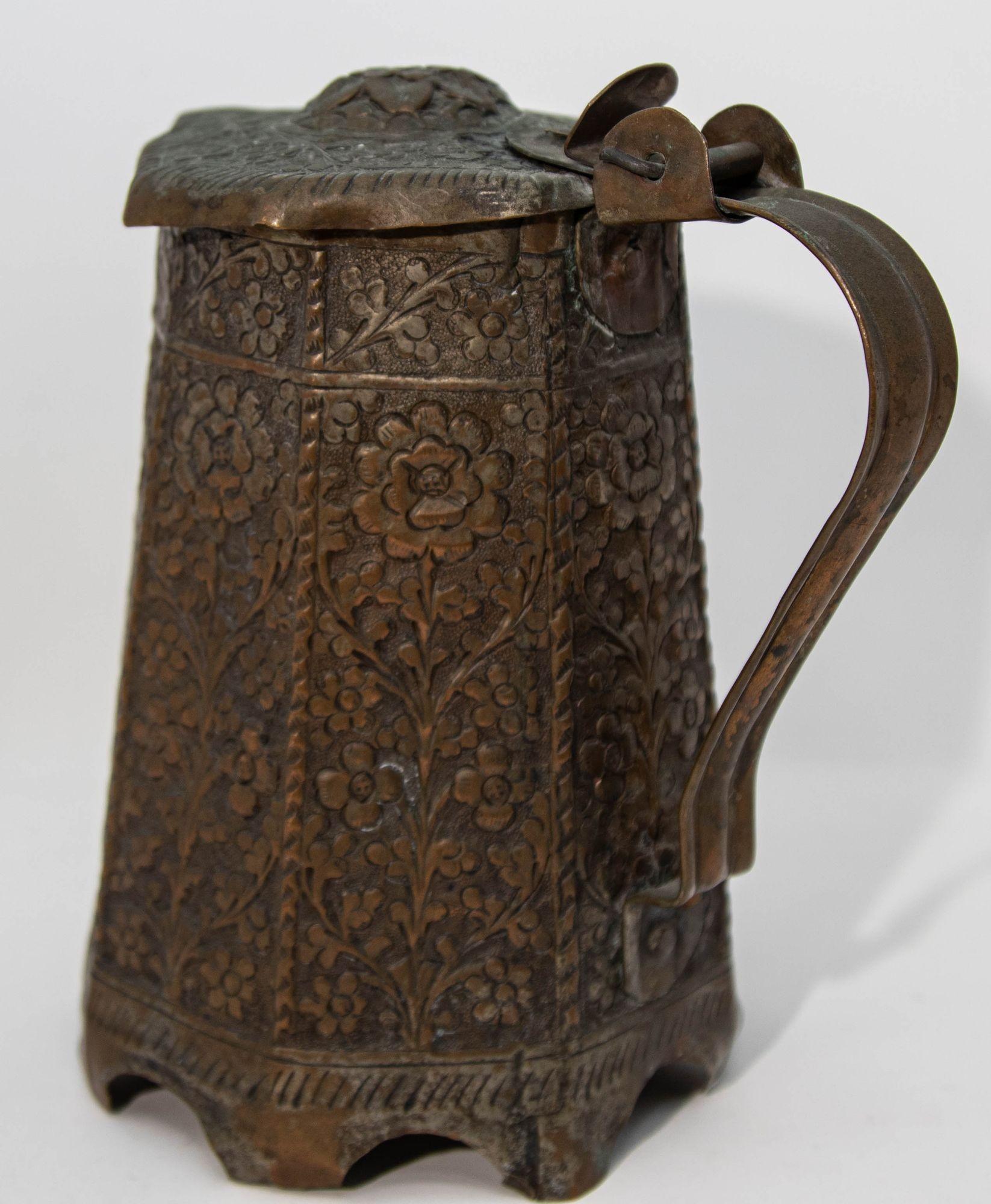 Antique 19th century Indo Persian copper tea or coffee pot with an arabesque pattern, embossed flower motif and tendril design.
Middle Eastern Arabian Persian style coffee pot in copper embossed with floral design.
Persian Copper In Collectible