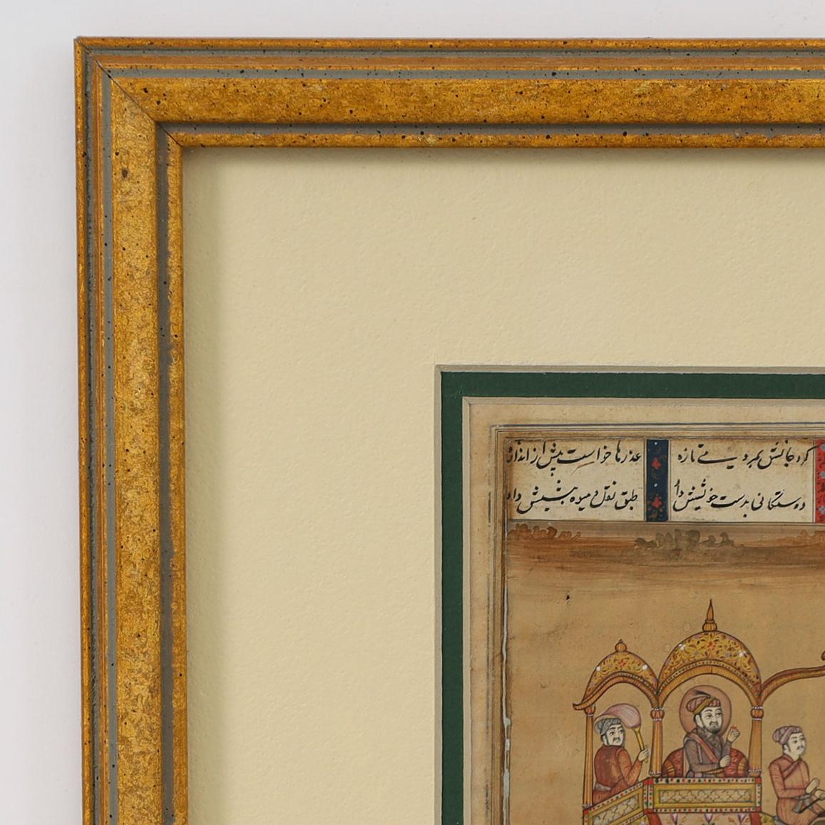 Charming 18th Century illustrated manuscript of an elephant with passengers executed in gouache on paper on the front and exposed manuscript on the back. Presented in a gold tone wood frame. 
