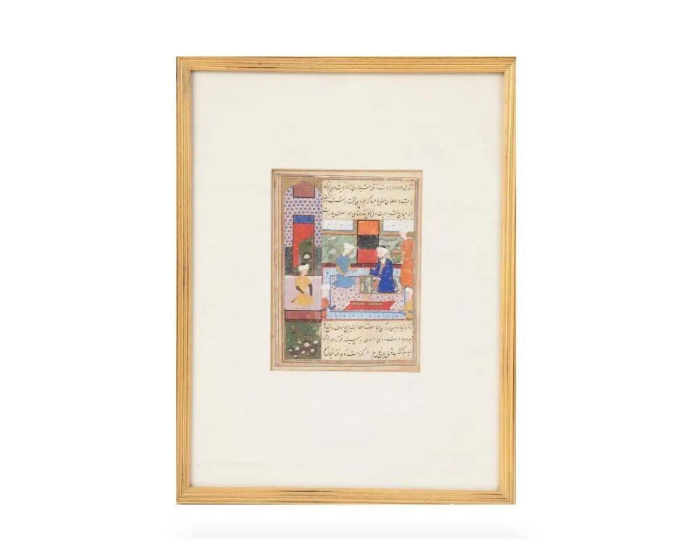 An antique Indo Persian Mughal Art miniature gouache painting on antique manuscript leaf depicting an interior scene with a prince surrounded by retinue painted in bold colors and with fine details. Carefully written with a Persian calligraphic text