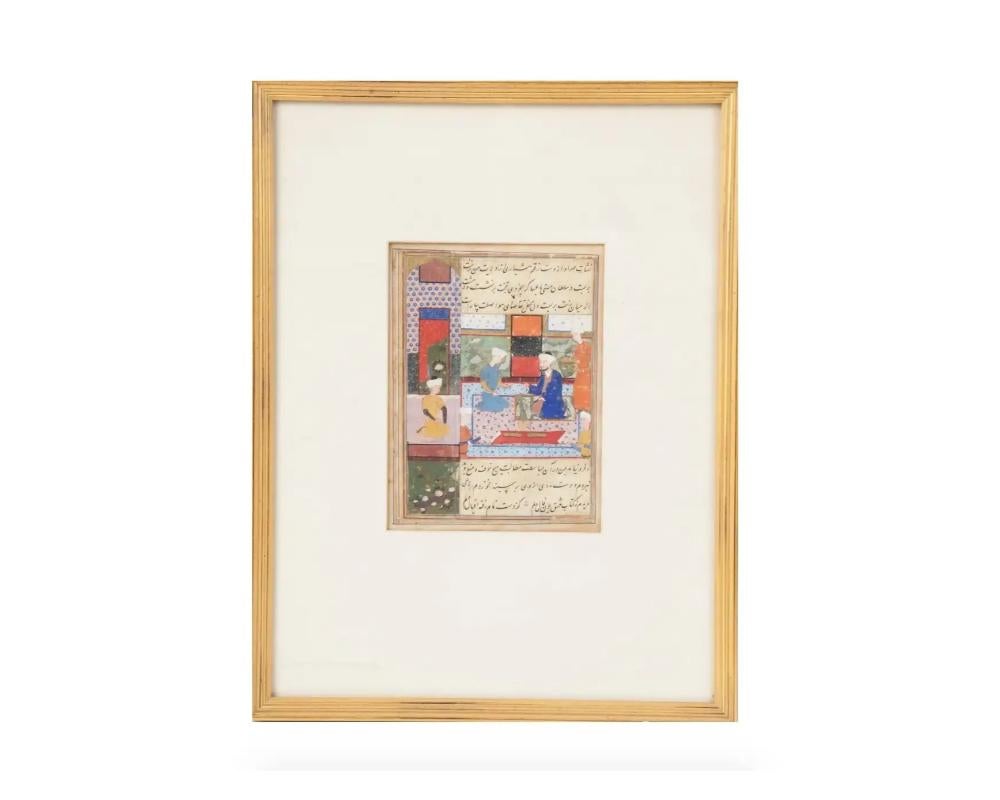 An antique Indo Persian Mughal Art miniature gouache painting on antique manuscript leaf depicting an outdoor scene with a prince surrounded by retinue in the garden painted in bold colors and with fine details framed by floral patterns. Carefully