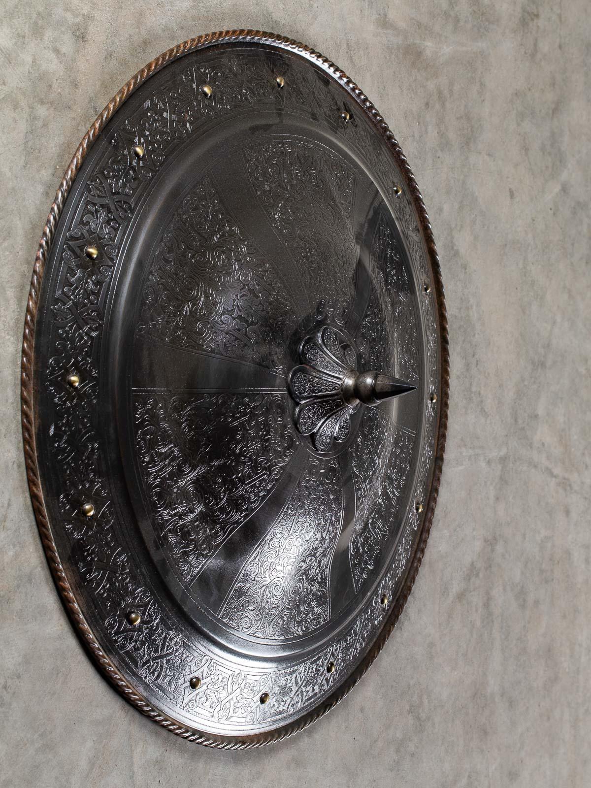 A superb Indo Persian round steel shield circa 1875 featuring a spike in the center along with intricate Damascene type engraved decoration. Please enlarge the photographs to see the details in closeup. Freshly polished to reveal the elaborately