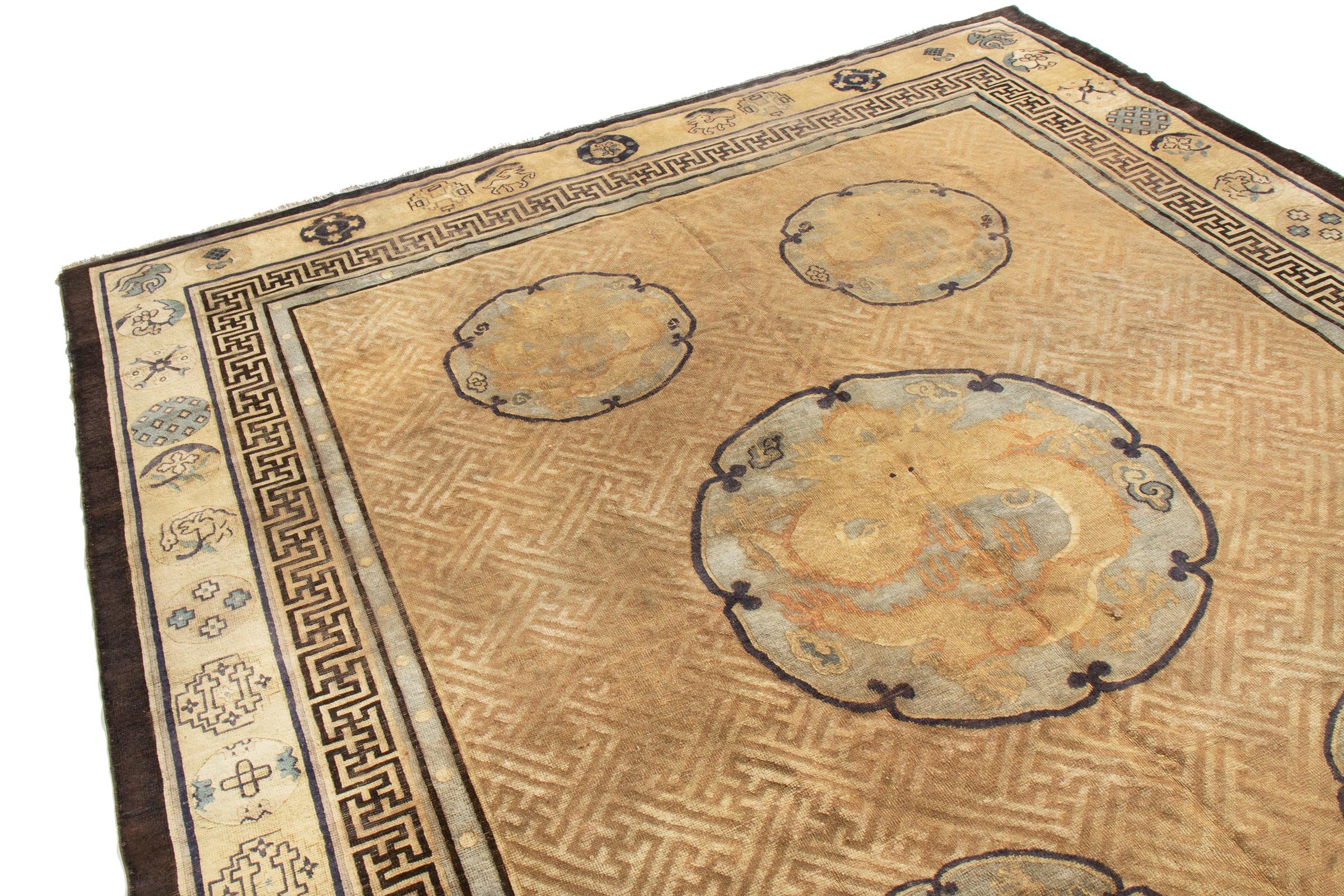 This antique traditional Indochinese floral rug has a culturally distinct combination of colors and imagery. The ornate medallion patterns of fearsome, rolling dragons are traditional symbols of power, honor, and dignity. The color plays into the