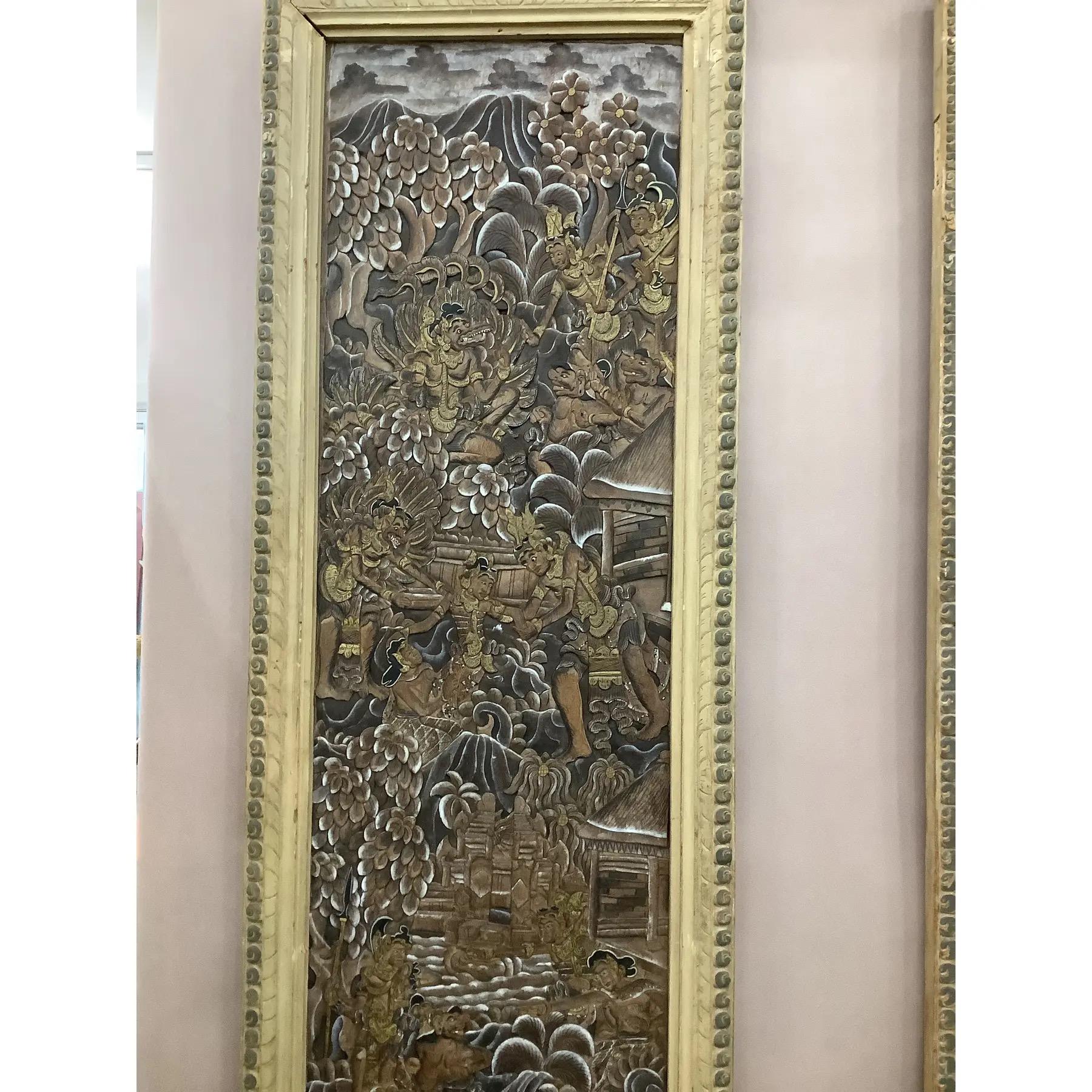 Antique Indonesian Four Panel Screen converted to wall art. Each panel with hand carved designs depicting mythical figures. Carved panels accented with gilt and painted highlights.
Each panel measures 66” x 18” x 1”