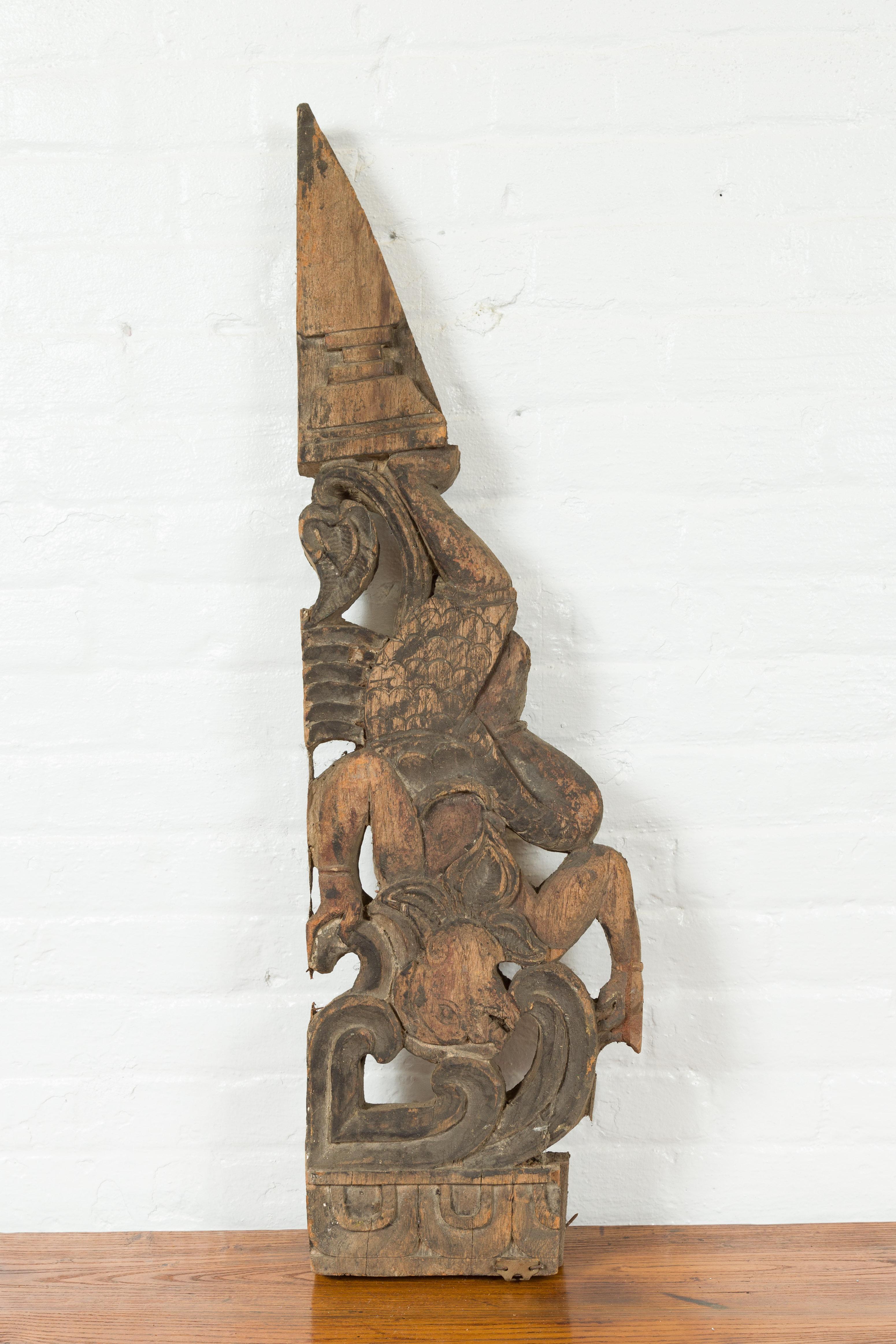 Antique Indonesian Carved Wooden Triangular Fragment Depicting a Falling Figure In Good Condition For Sale In Yonkers, NY