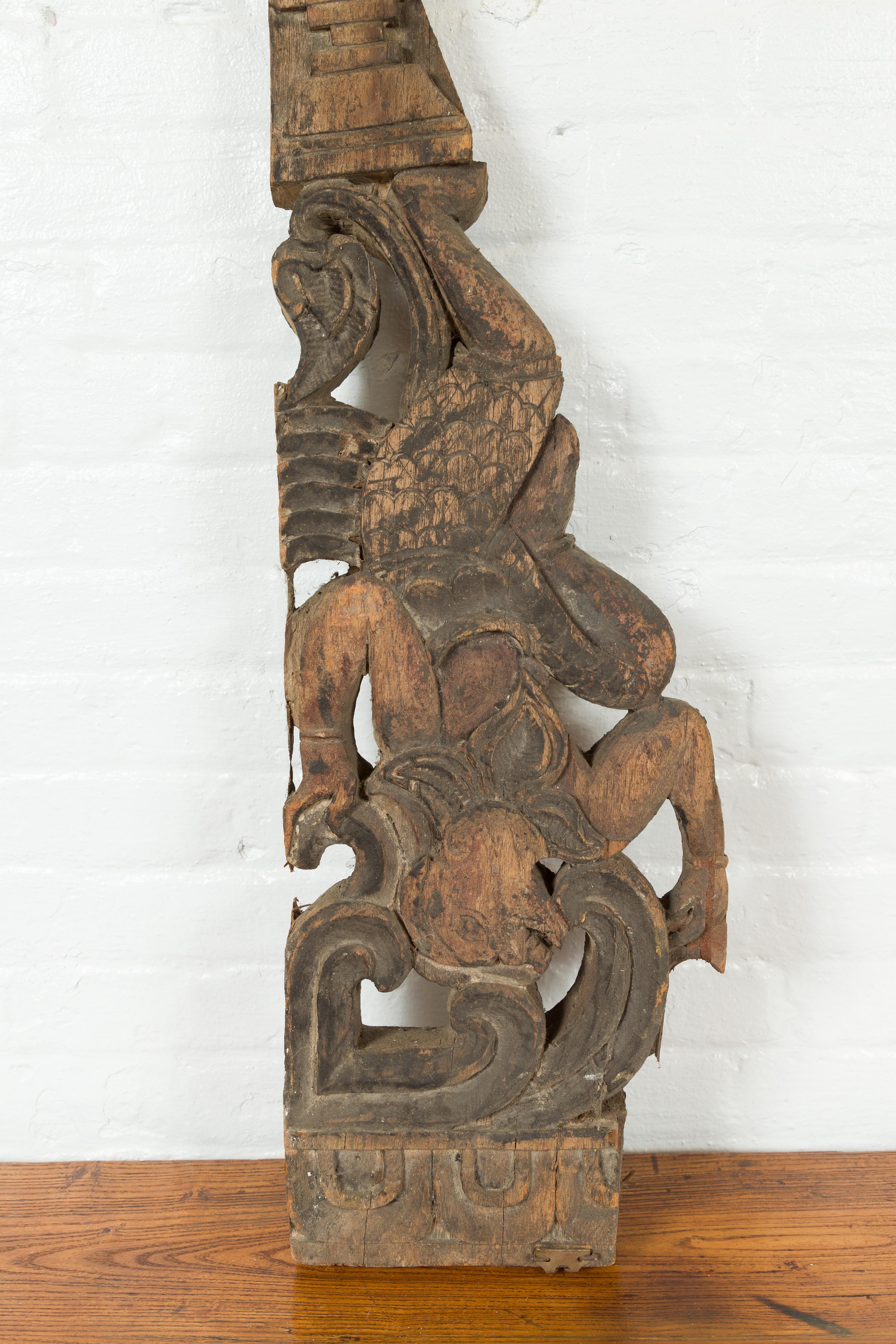 19th Century Antique Indonesian Carved Wooden Triangular Fragment Depicting a Falling Figure For Sale